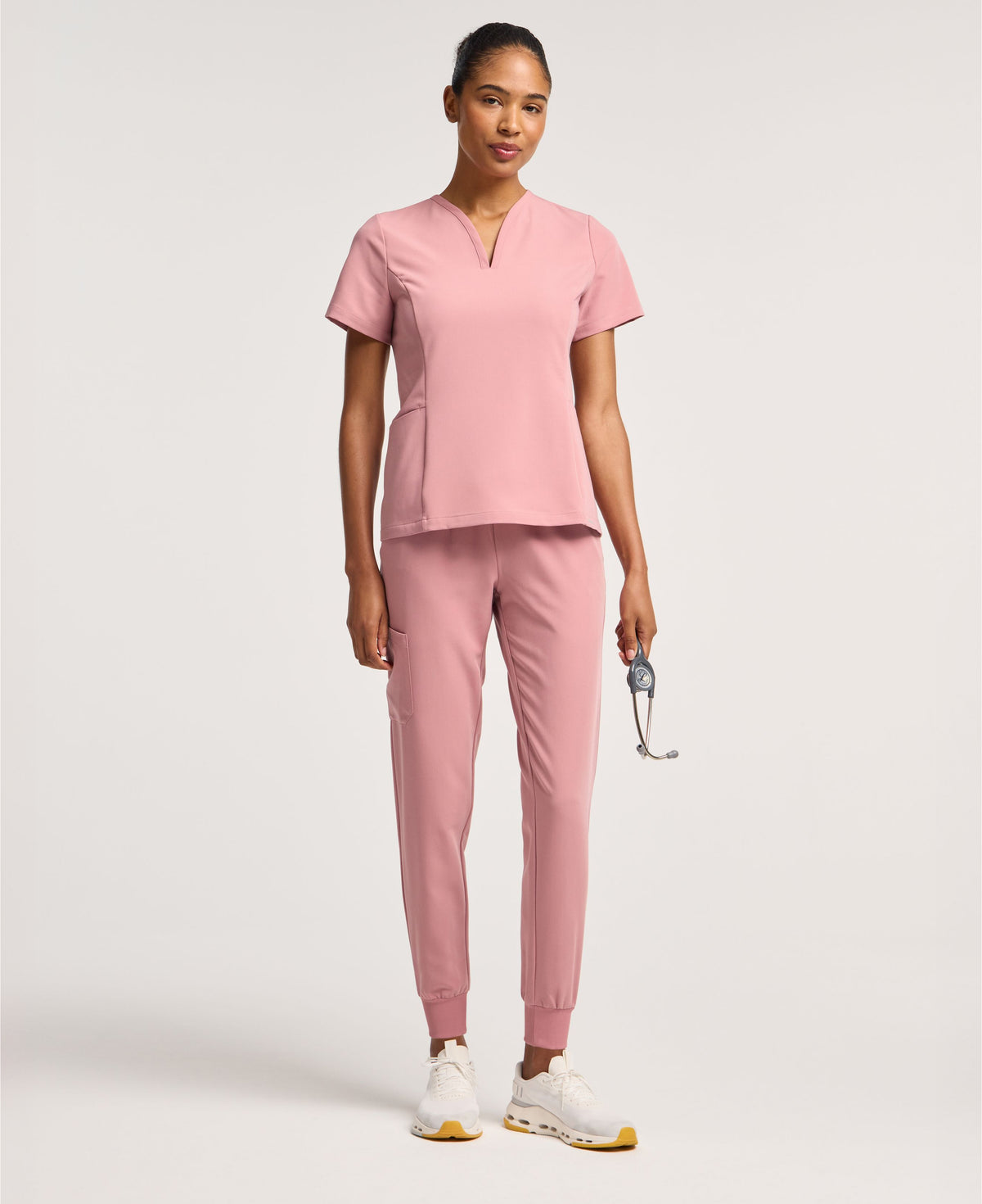 Jaanuu Calix Fit & Flare Scrub Top in Mauve, product photo 1 of 6