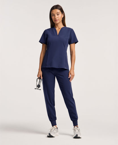 Jaanuu Calix Fit & Flare Scrub Top in Midnight Navy, product photo 1 of 6
