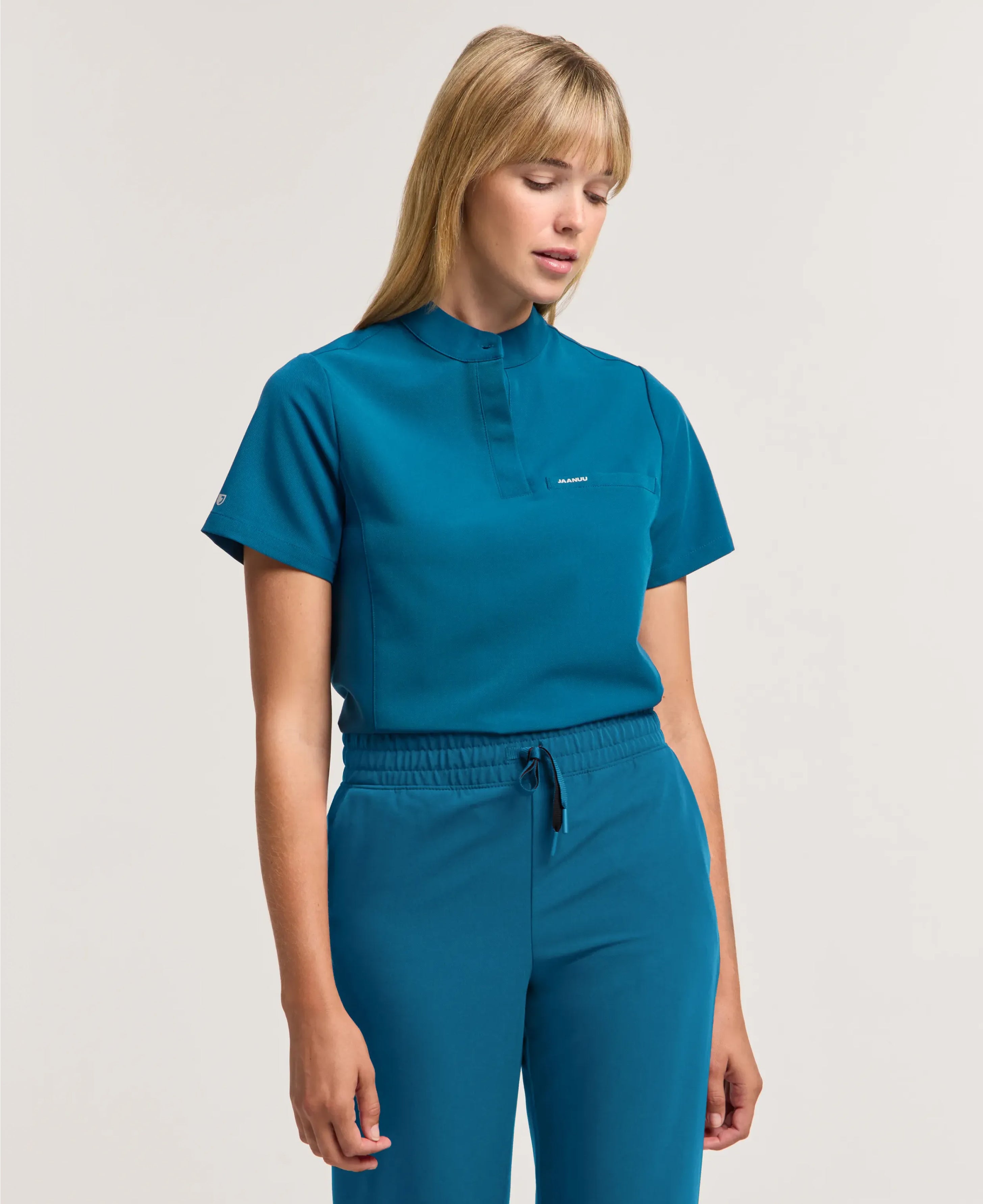 Jaanuu Savi Stand-Collar Scrub Top in Caribbean Blue, product photo 1 of 6