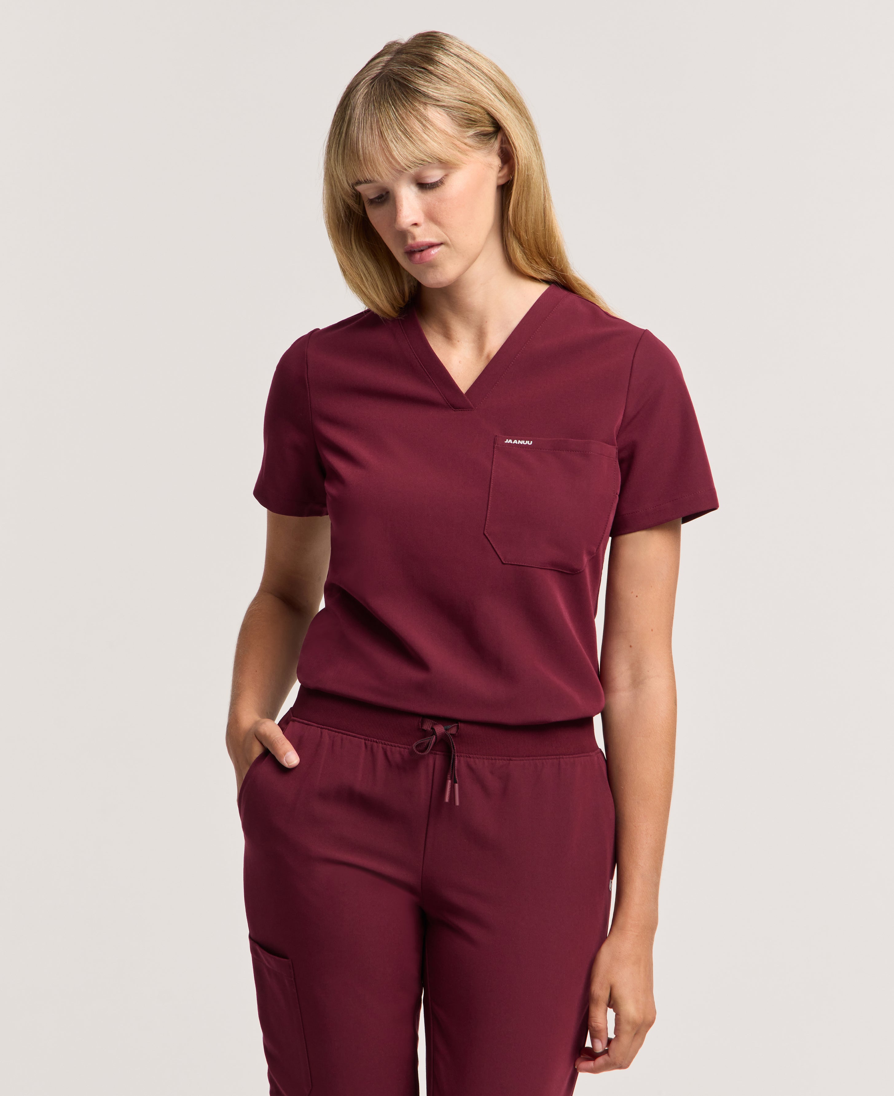 Jaanuu Rhena Slim 1-Pocket Scrub Top in Burgundy, product photo 1 of 6