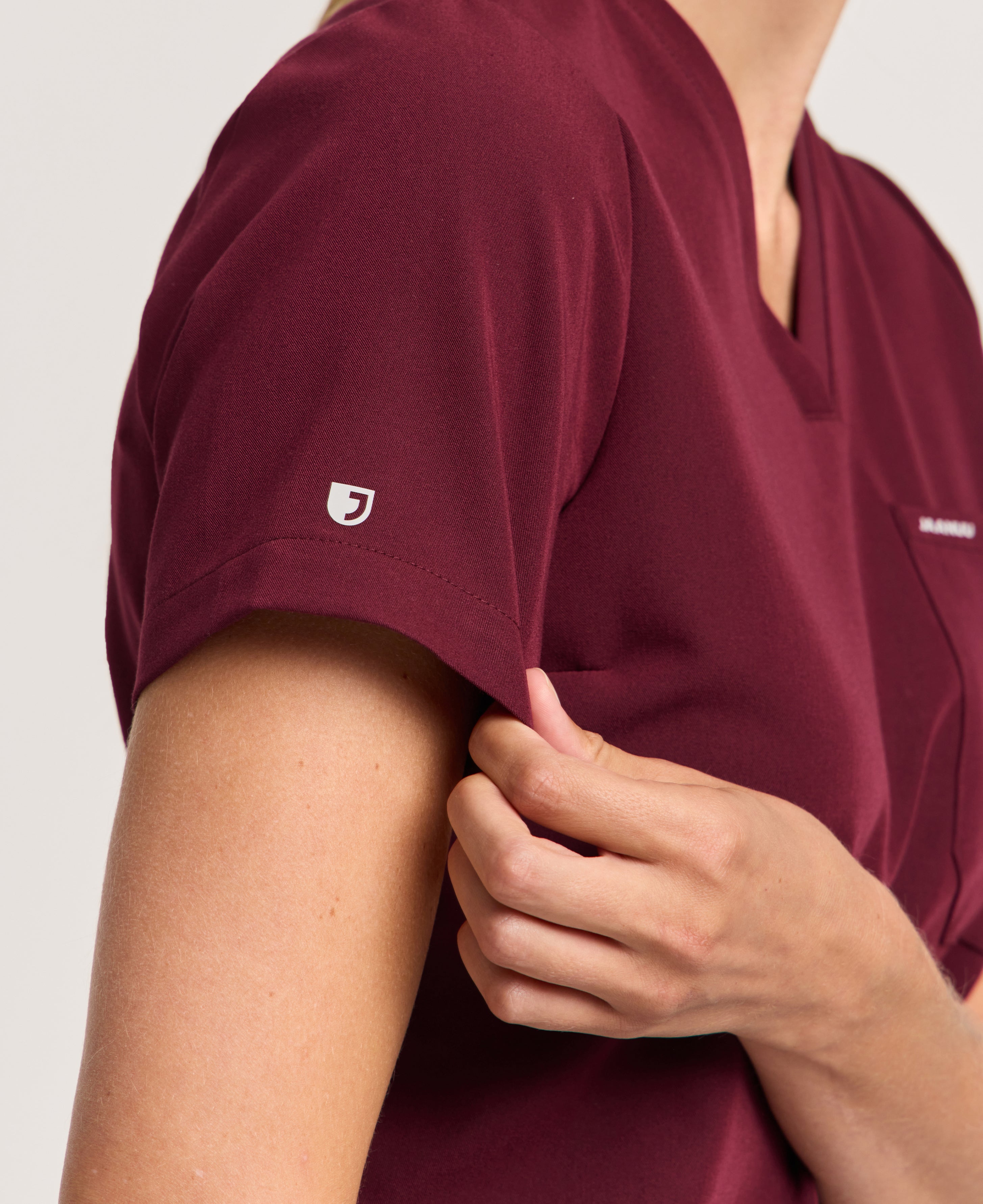 Jaanuu Rhena Slim 1-Pocket Scrub Top in Burgundy, product photo 3 of 6