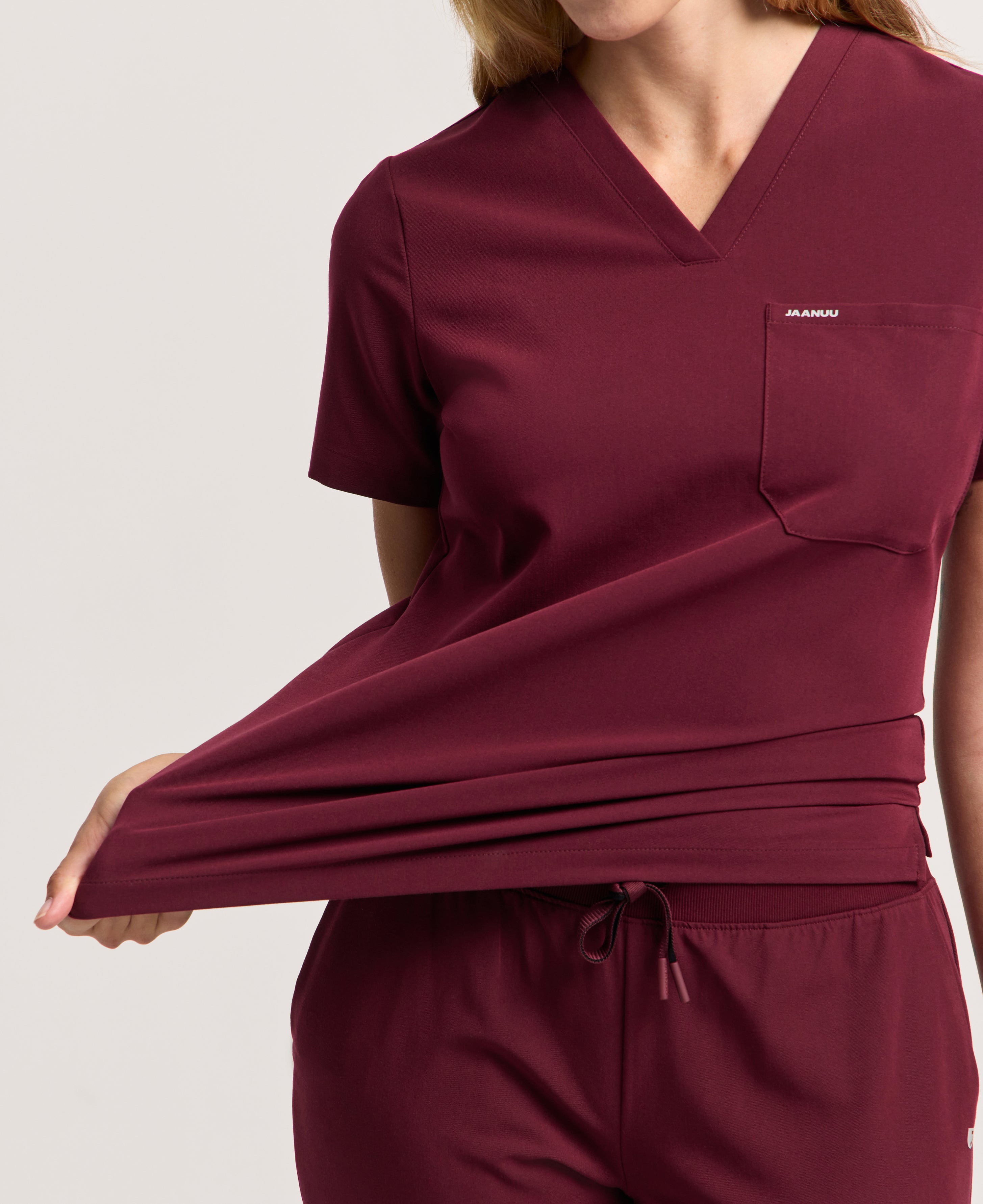 Jaanuu Rhena Slim 1-Pocket Scrub Top in Burgundy, product photo 4 of 6