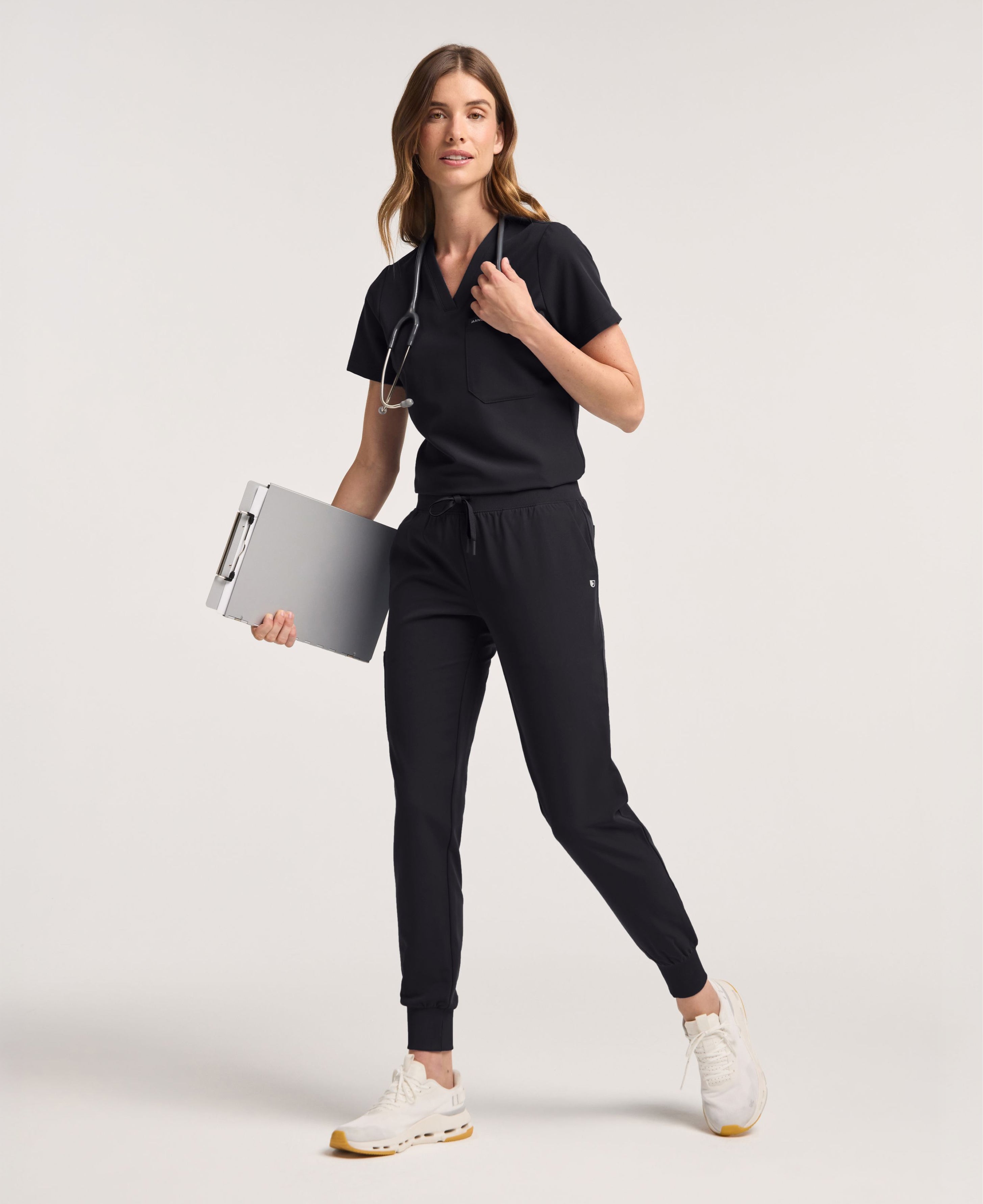 Jaanuu Rhena Slim 1-Pocket Scrub Top in Black, product photo 1 of 6