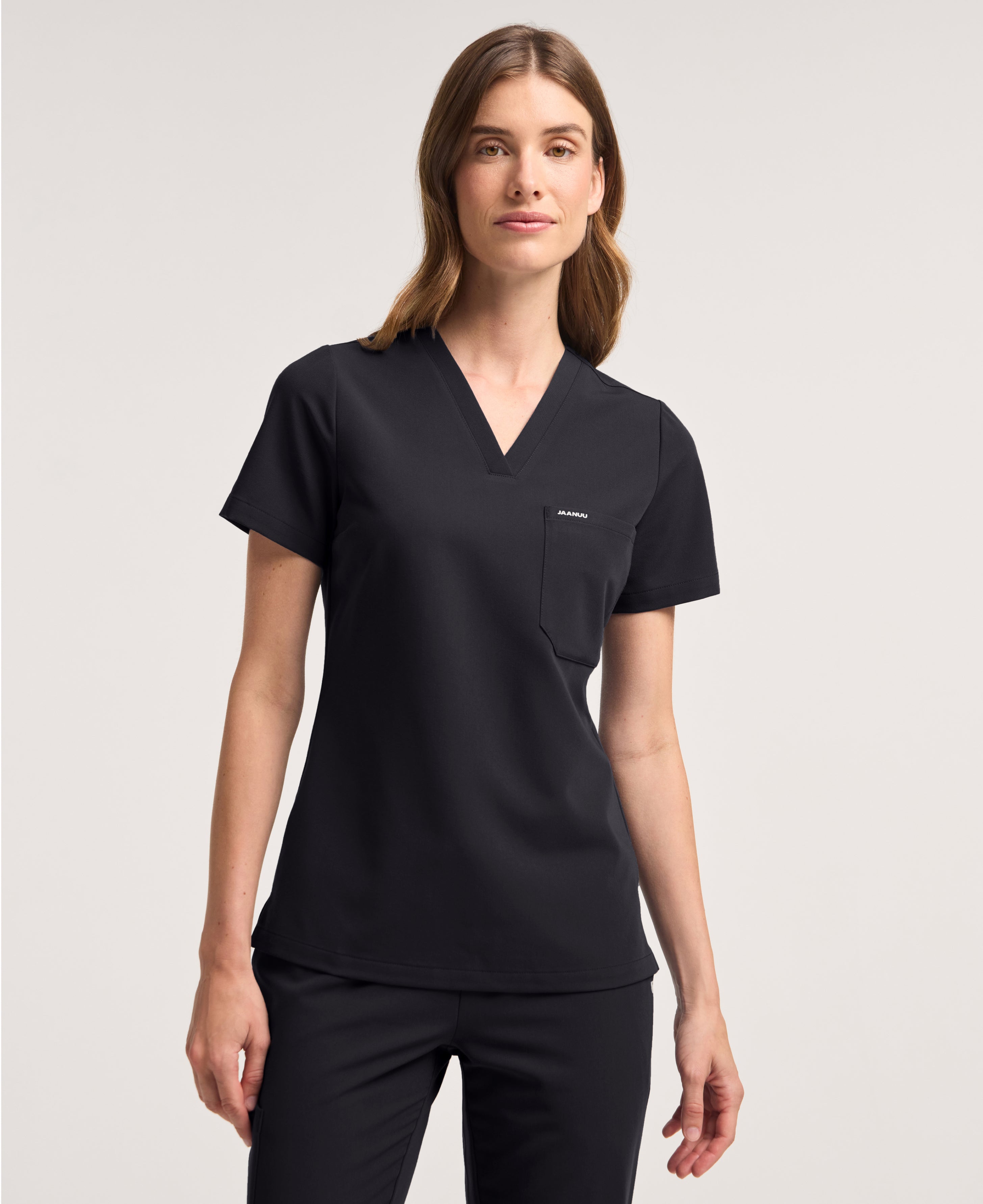 Jaanuu Rhena Slim 1-Pocket Scrub Top in Black, product photo 3 of 6