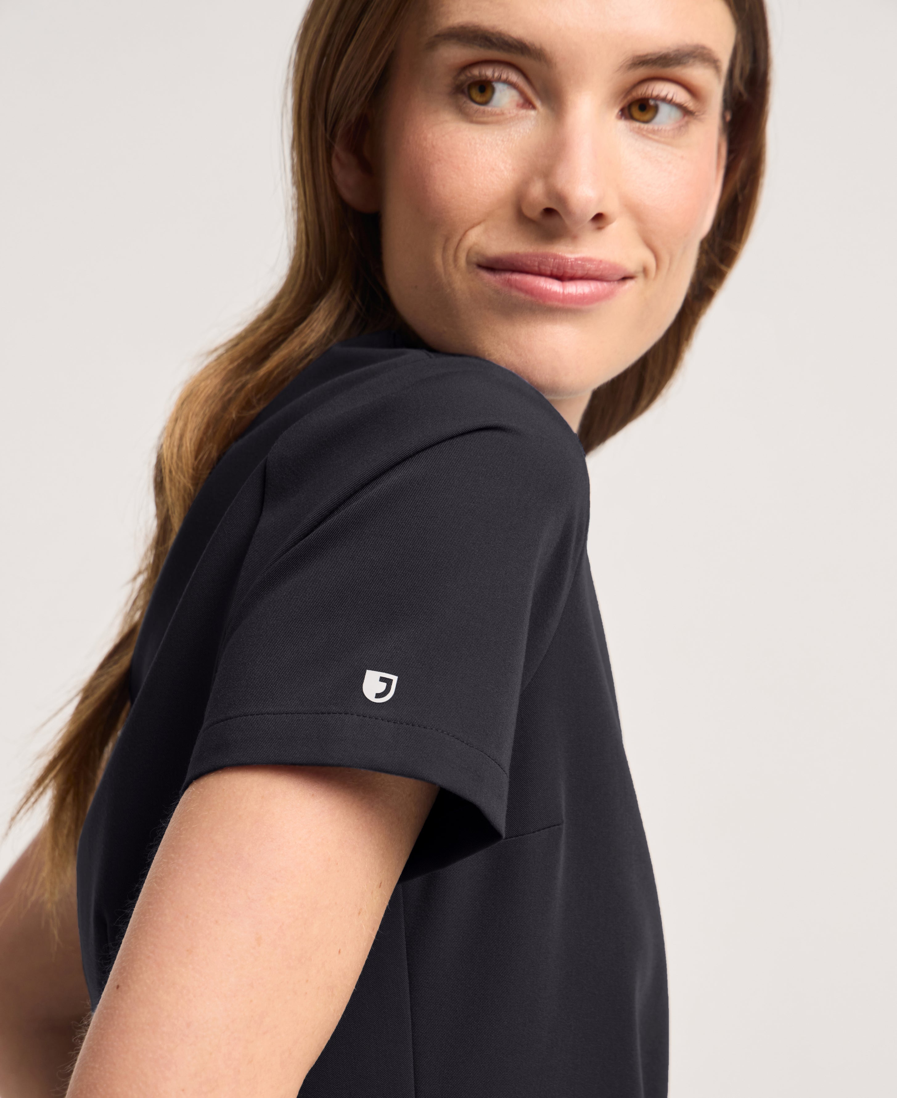 Jaanuu Rhena Slim 1-Pocket Scrub Top in Black, product photo 5 of 6