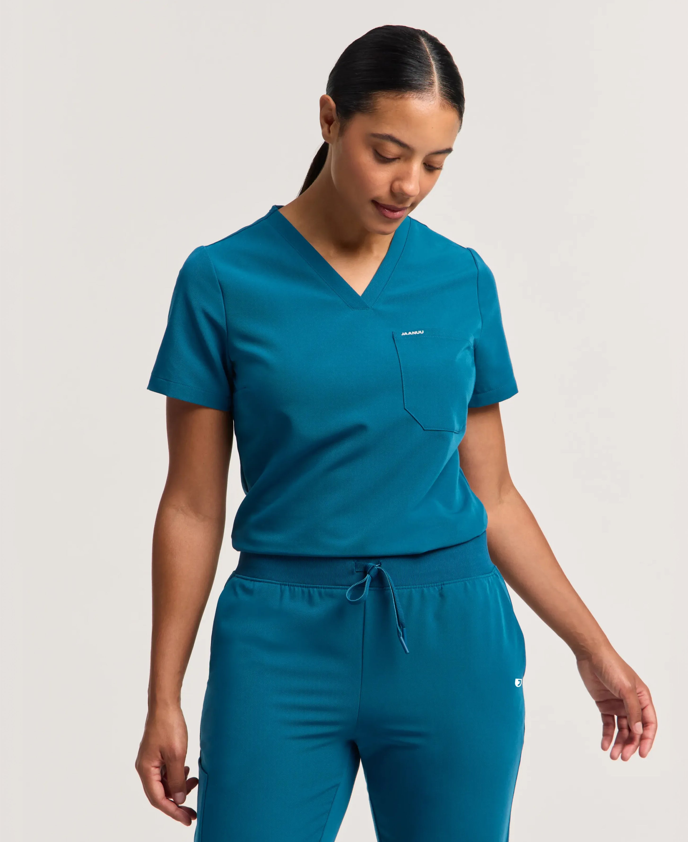 Jaanuu Rhena Slim 1-Pocket Scrub Top in Caribbean Blue, product photo 3 of 6