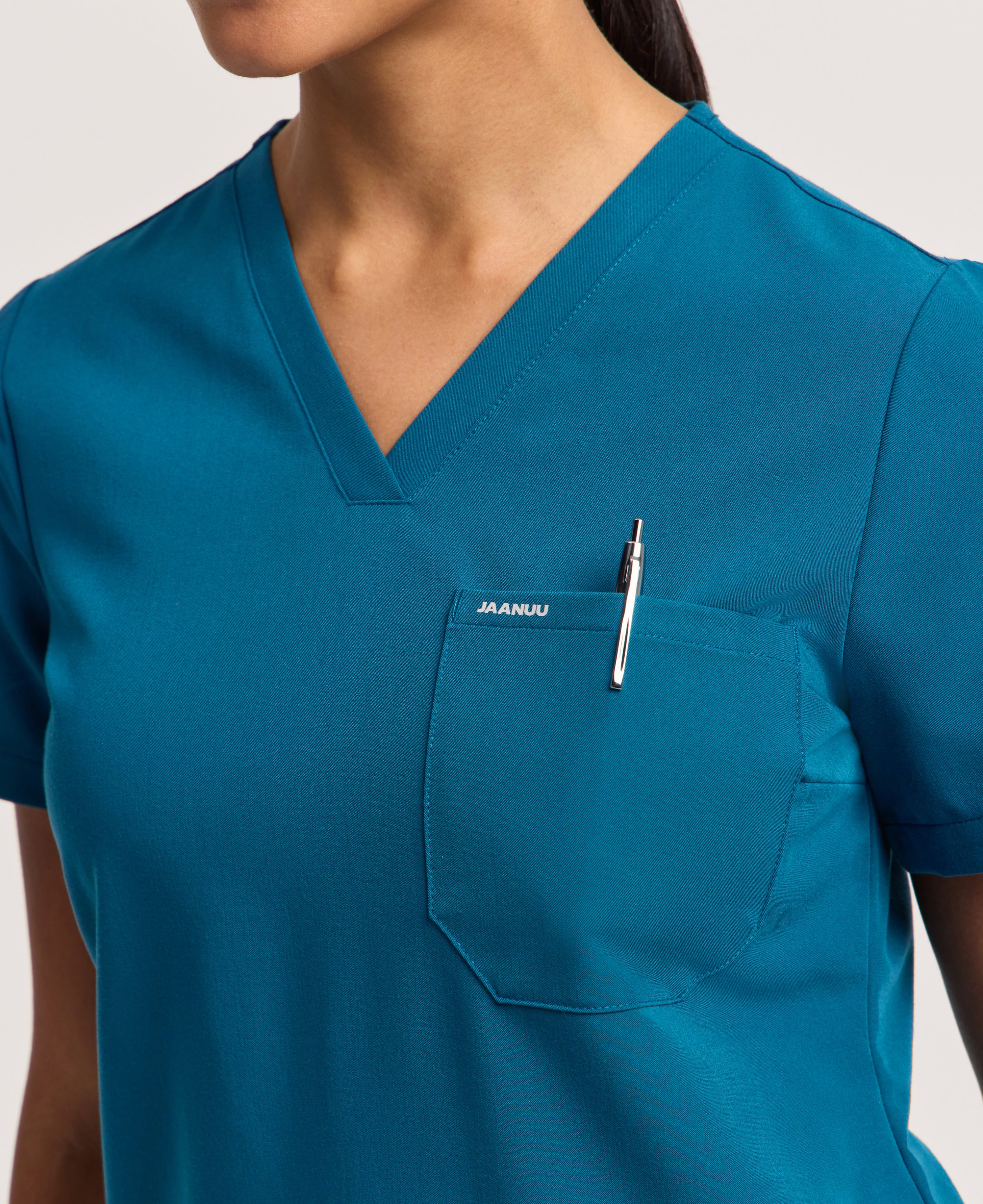 Jaanuu Rhena Slim 1-Pocket Scrub Top in Caribbean Blue, product photo 4 of 6