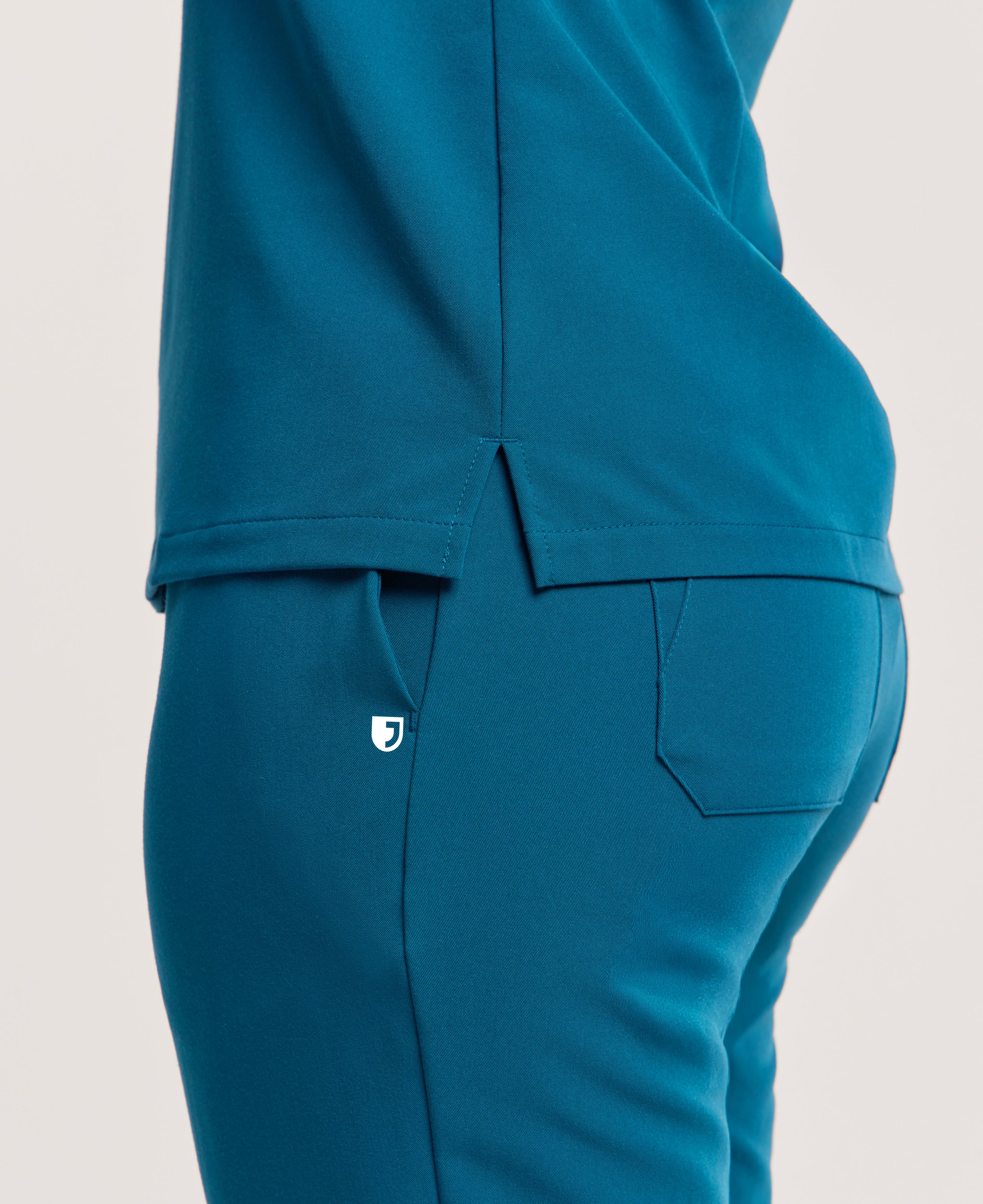 Jaanuu Rhena Slim 1-Pocket Scrub Top in Caribbean Blue, product photo 5 of 6