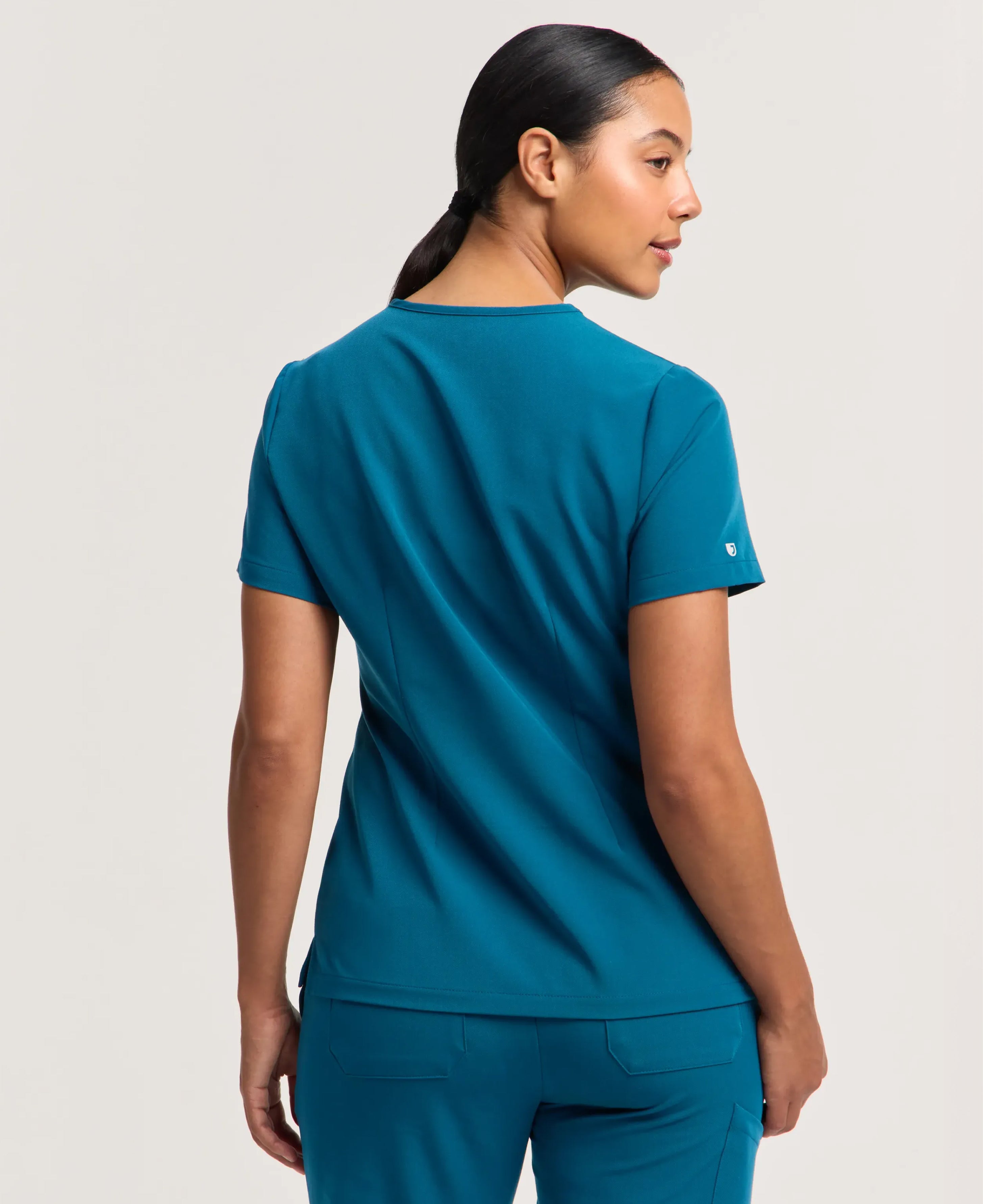 Jaanuu Rhena Slim 1-Pocket Scrub Top in Caribbean Blue, product photo 6 of 6