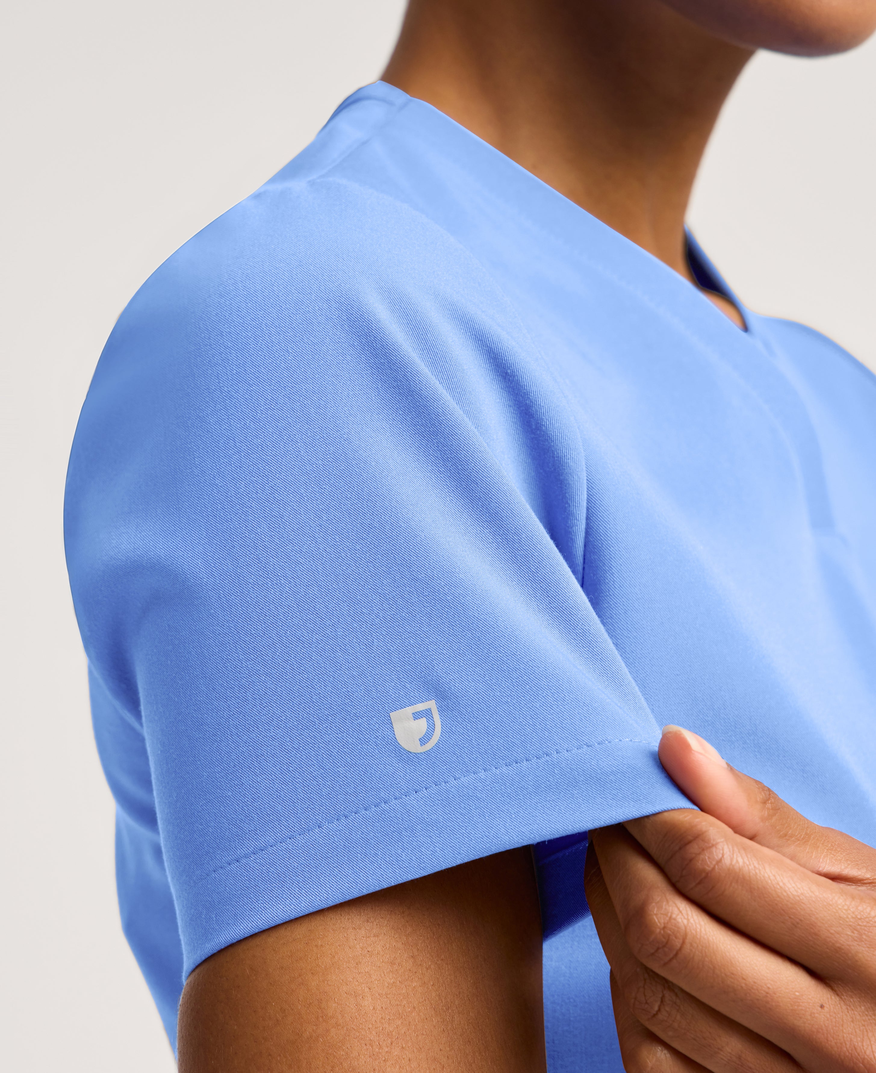 Jaanuu Rhena Slim 1-Pocket Scrub Top in Ceil Blue, product photo 4 of 6