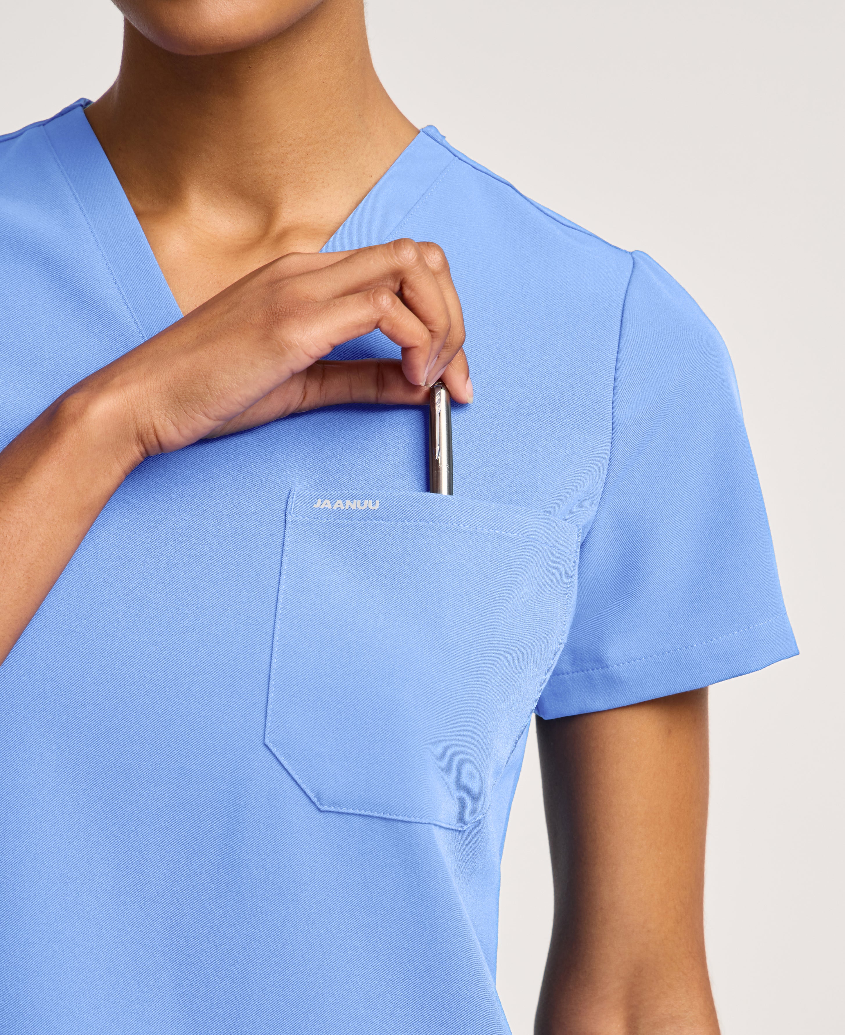 Jaanuu Rhena Slim 1-Pocket Scrub Top in Ceil Blue, product photo 5 of 6