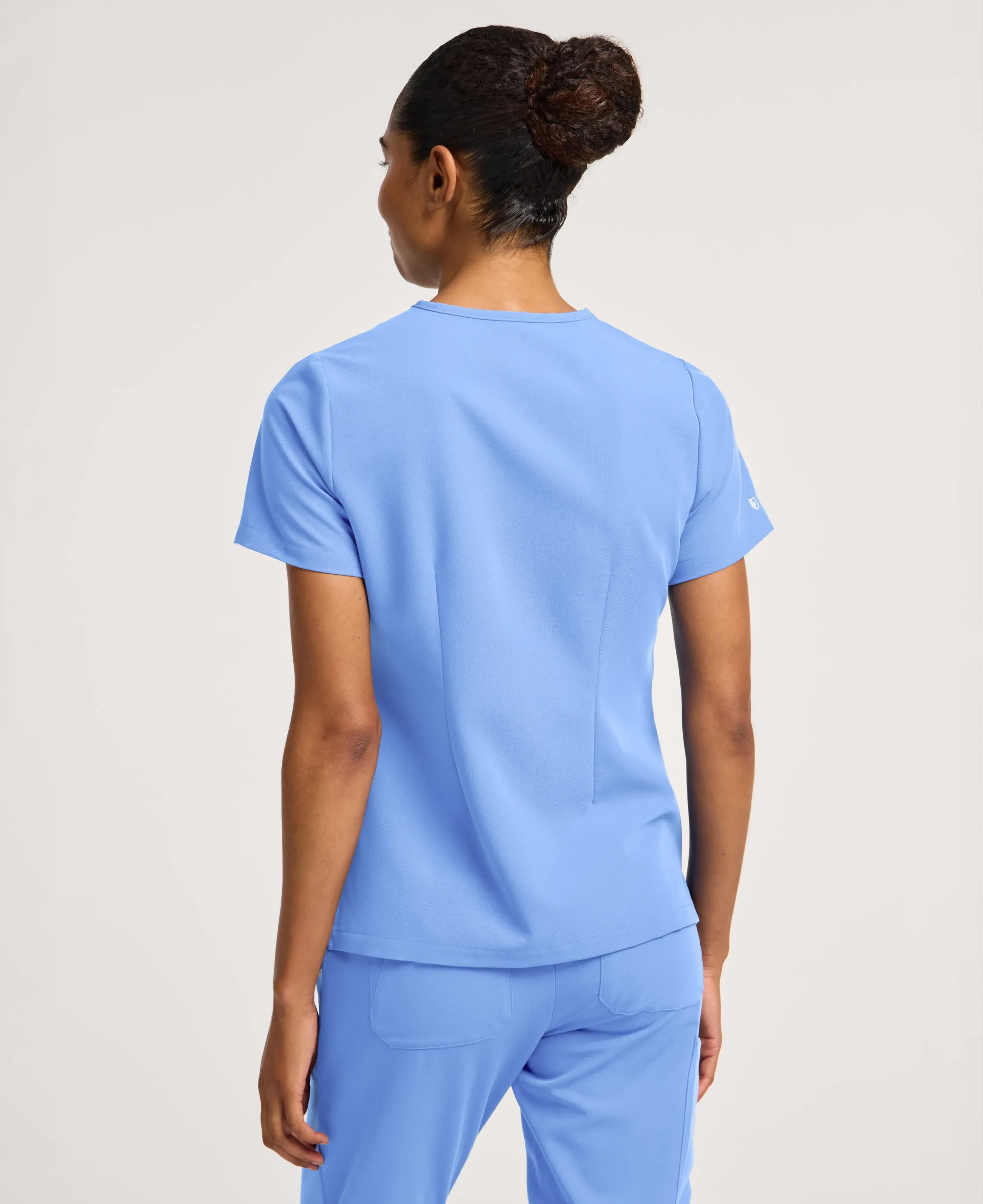 Jaanuu Rhena Slim 1-Pocket Scrub Top in Ceil Blue, product photo 6 of 6
