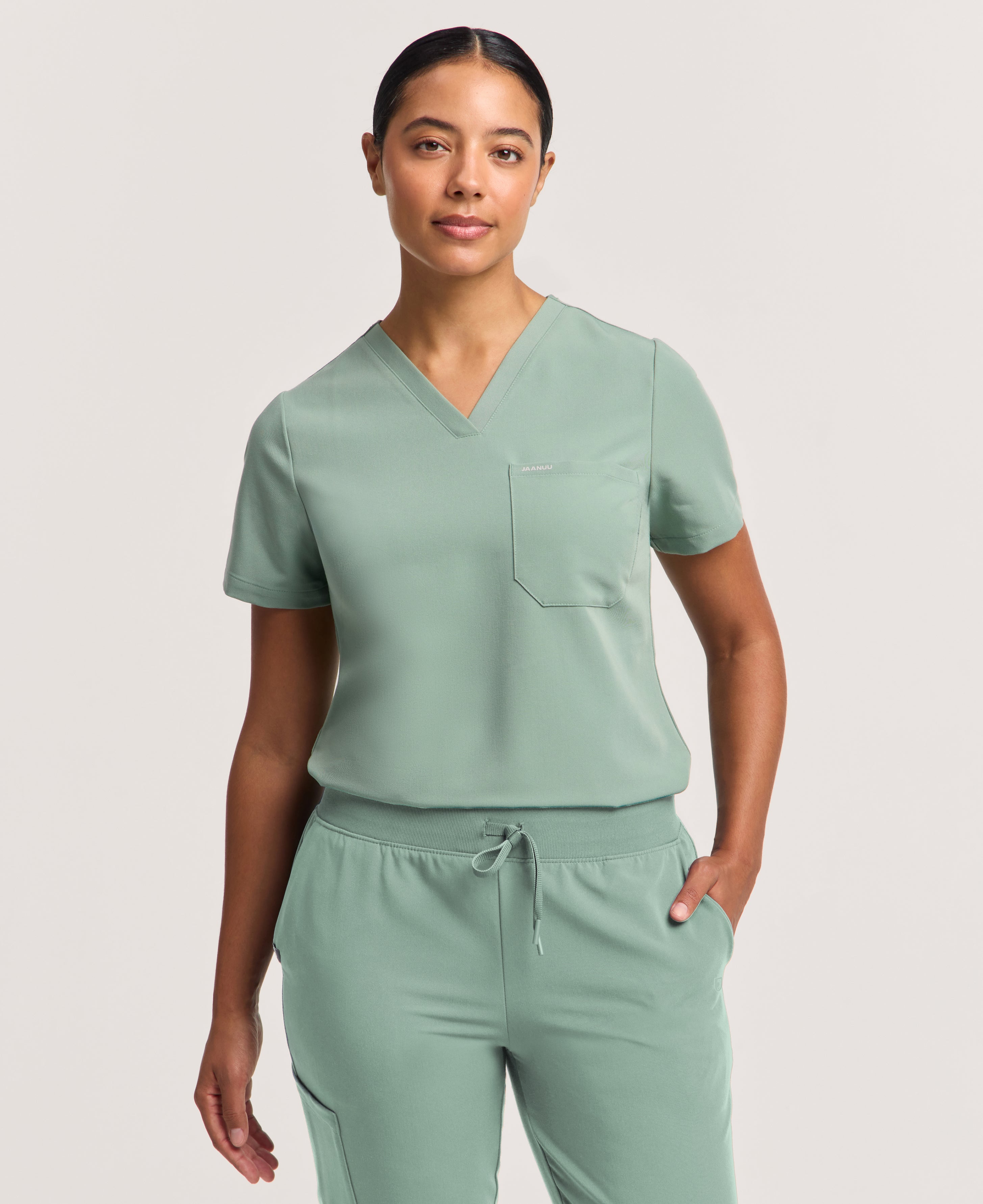 Jaanuu Rhena Slim 1-Pocket Scrub Top in Sage, product photo 1 of 6