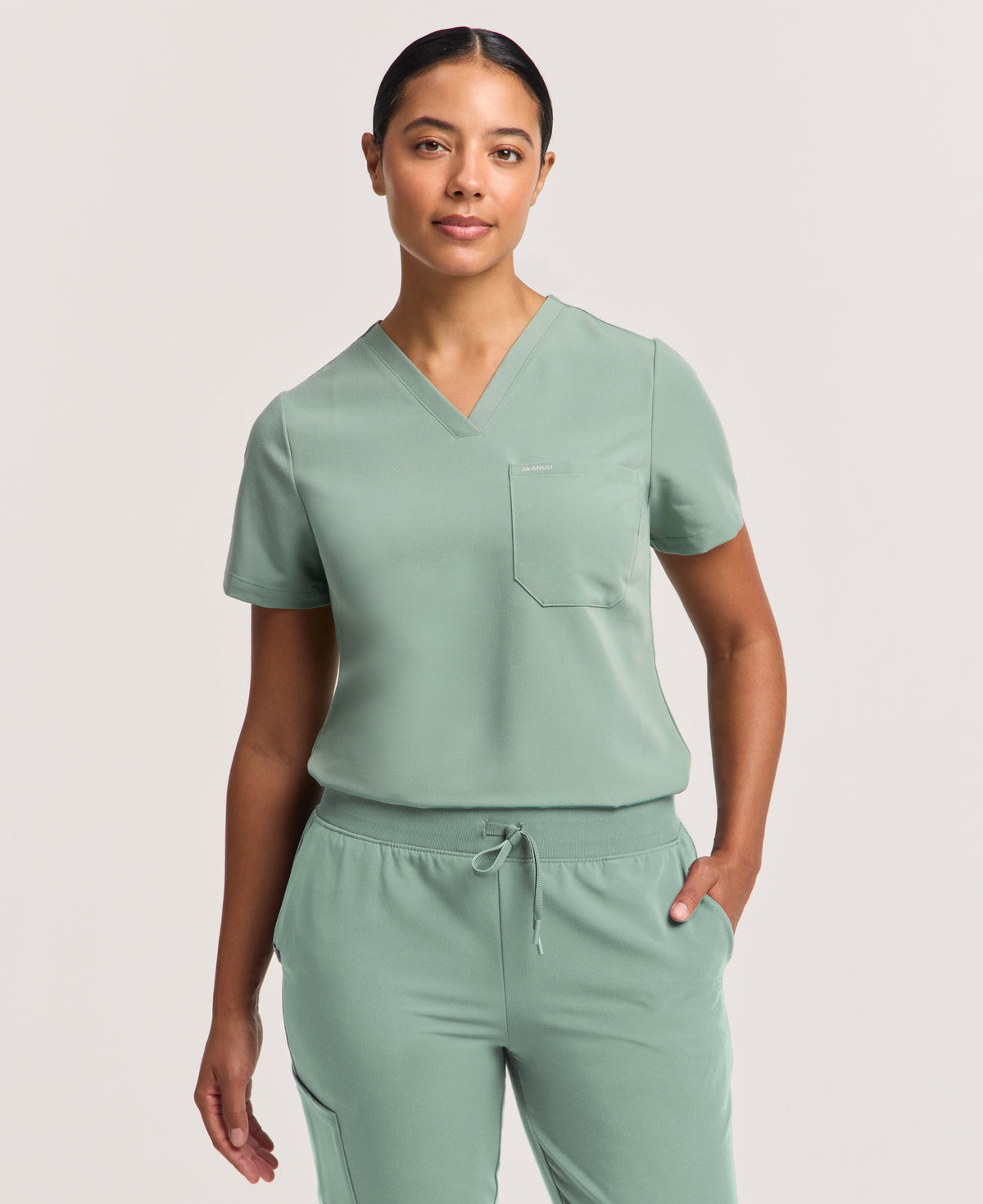 Jaanuu Rhena Slim 1-Pocket Scrub Top in Sage, product photo 1 of 6