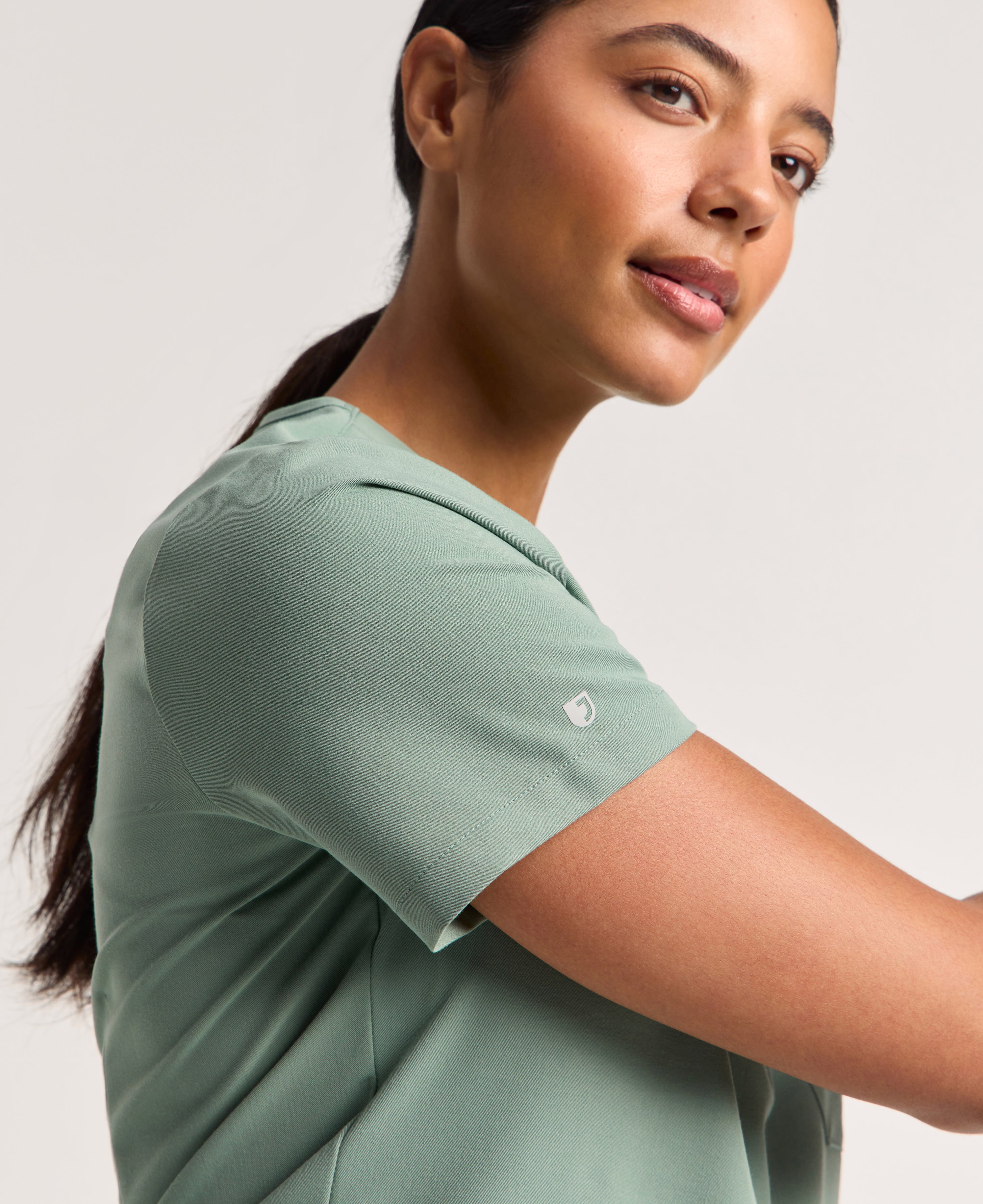 Jaanuu Rhena Slim 1-Pocket Scrub Top in Sage, product photo 3 of 6