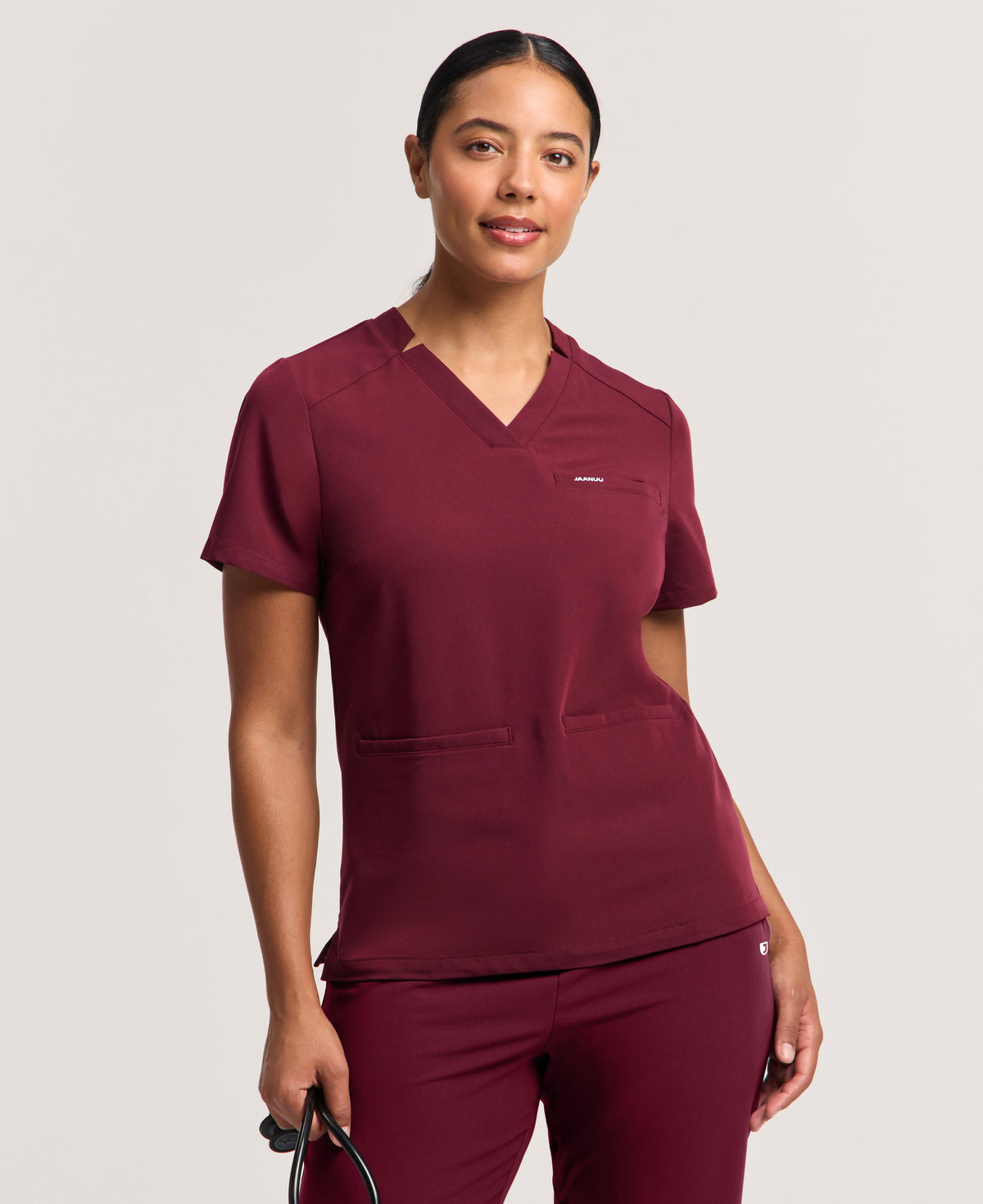 Jaanuu Helia Slim Notched V-Neck Scrub Top in Burgundy, product photo 1 of 6