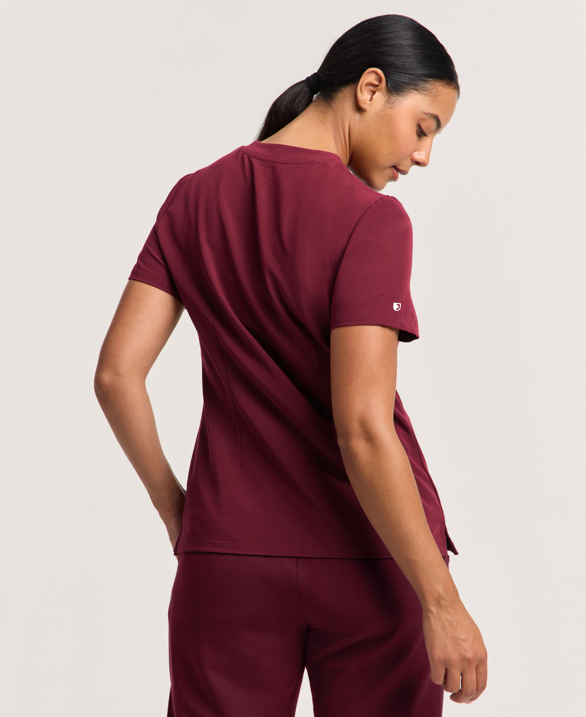 Jaanuu Helia Slim Notched V-Neck Scrub Top in Burgundy, product photo 4 of 6