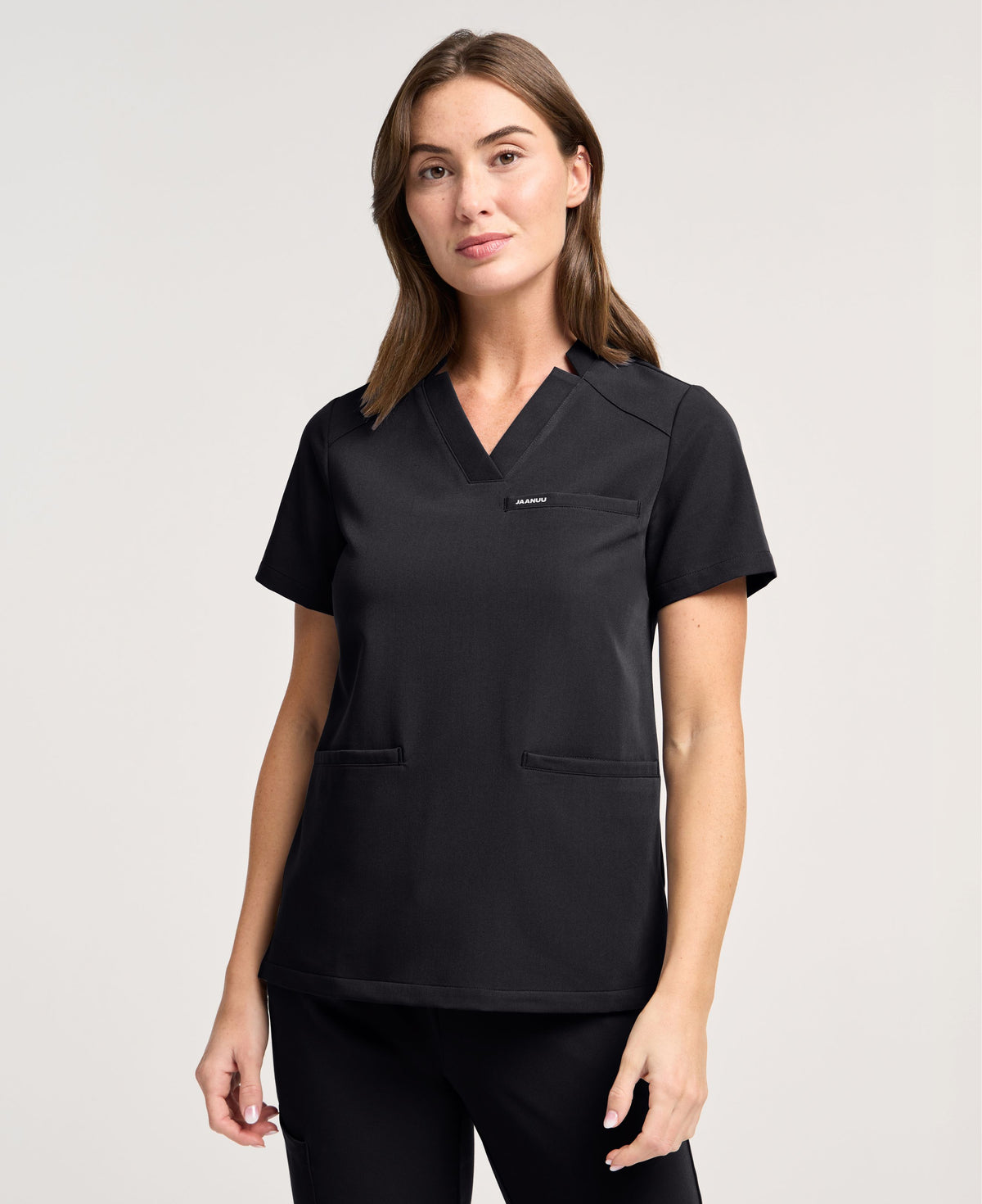 Jaanuu Helia Slim Notched V-Neck Scrub Top in Black, product photo 1 of 6