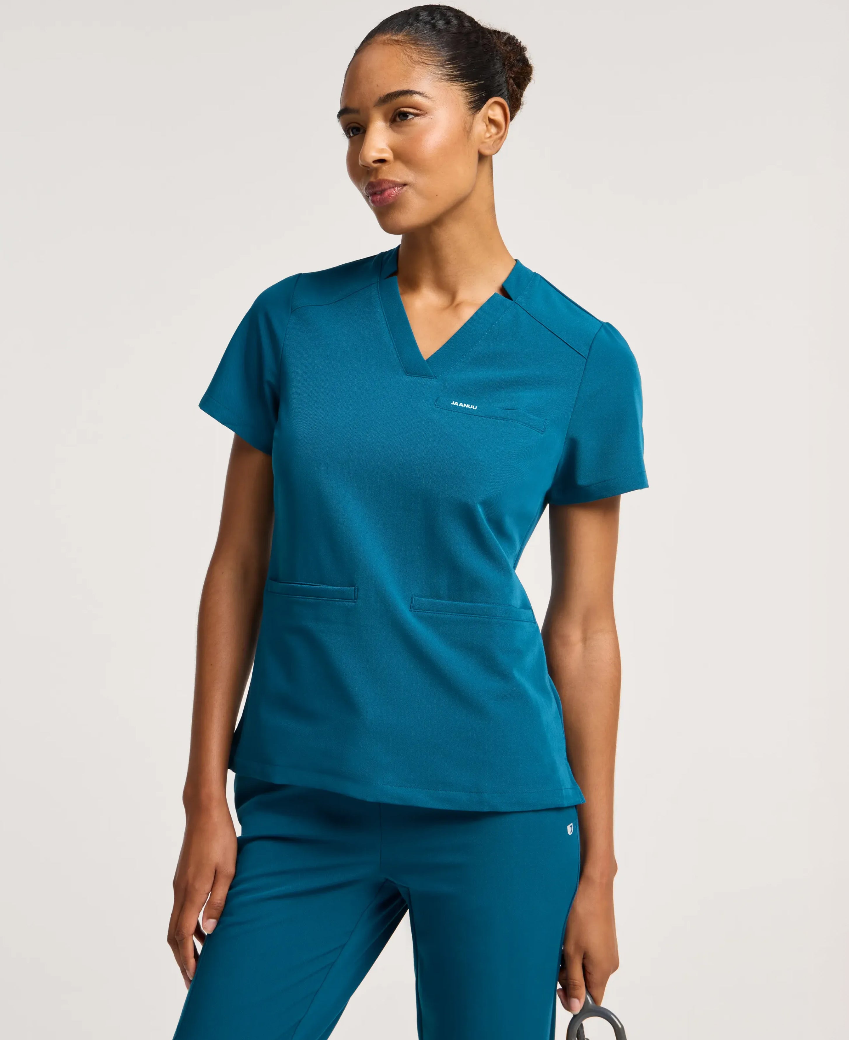 Jaanuu Helia Slim Notched V-Neck Scrub Top in Caribbean Blue, product photo 1 of 6