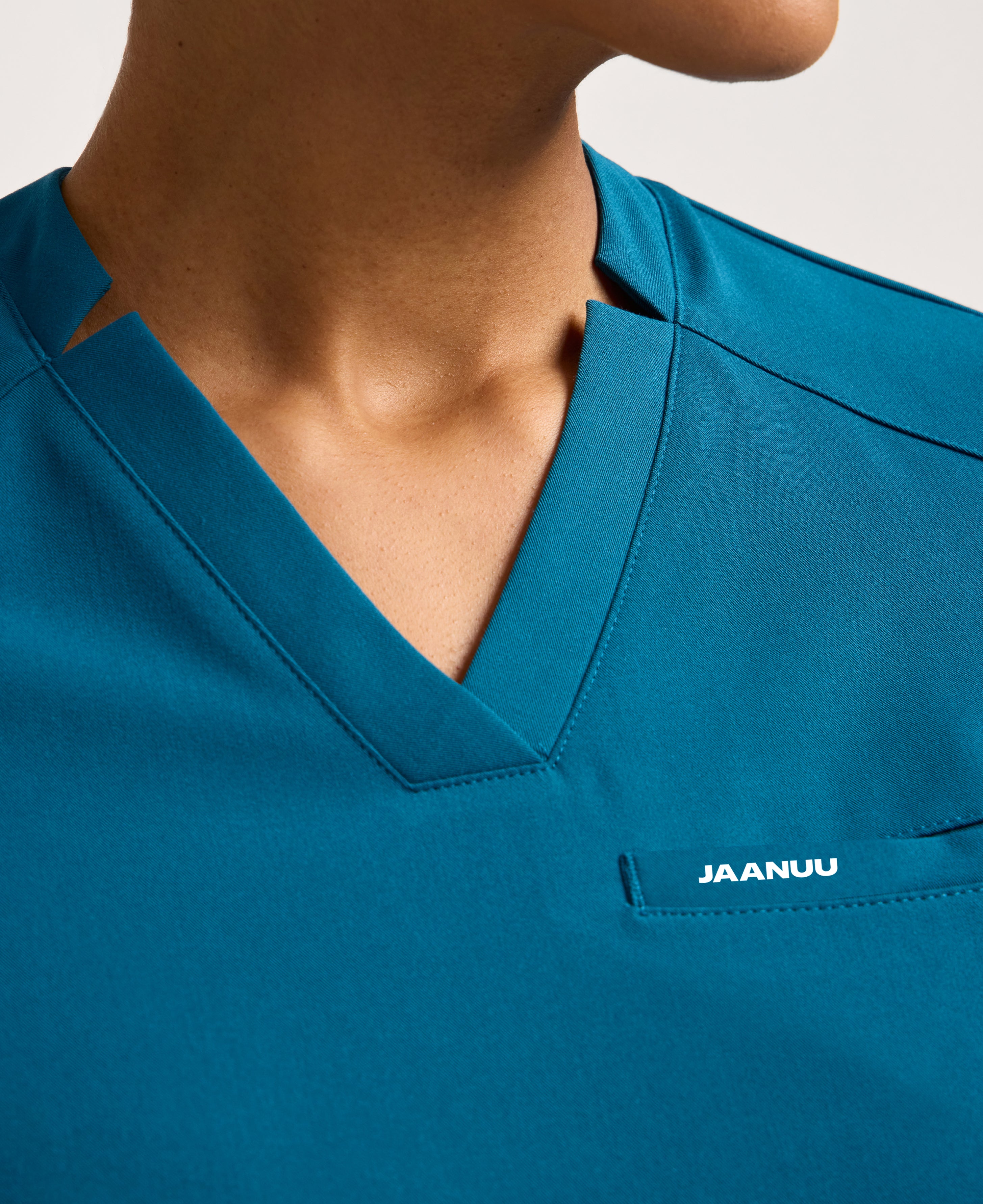 Jaanuu Helia Slim Notched V-Neck Scrub Top in Caribbean Blue, product photo 2 of 6
