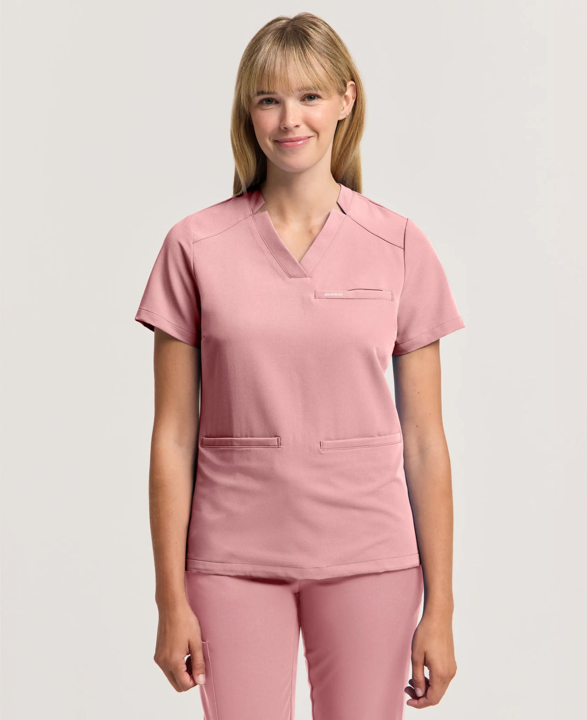 Jaanuu Helia Slim Notched V-Neck Scrub Top in Mauve, product photo 1 of 6