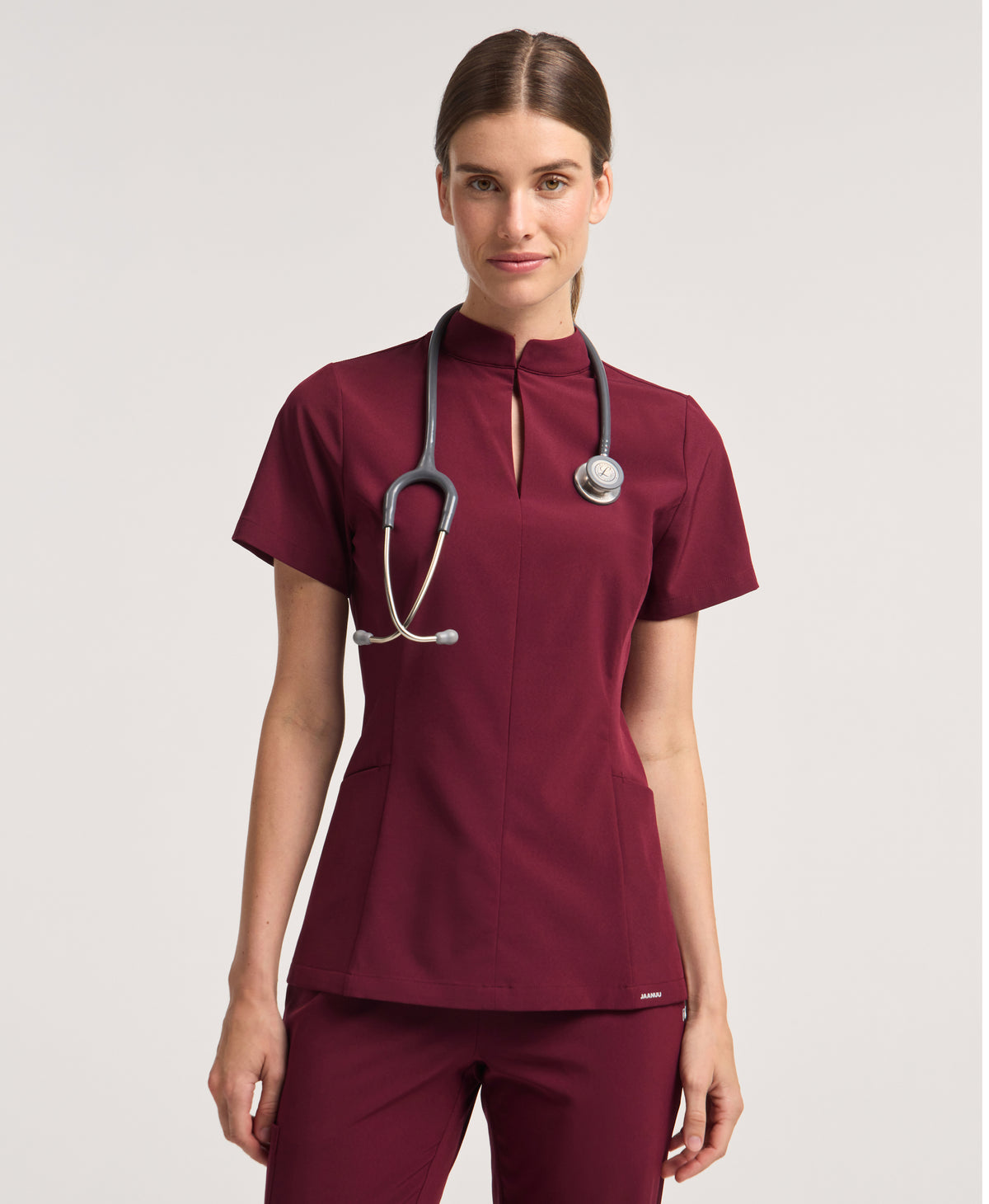 Jaanuu Alex Mock-Neck Scrub Top in Burgundy, product photo 1 of 6