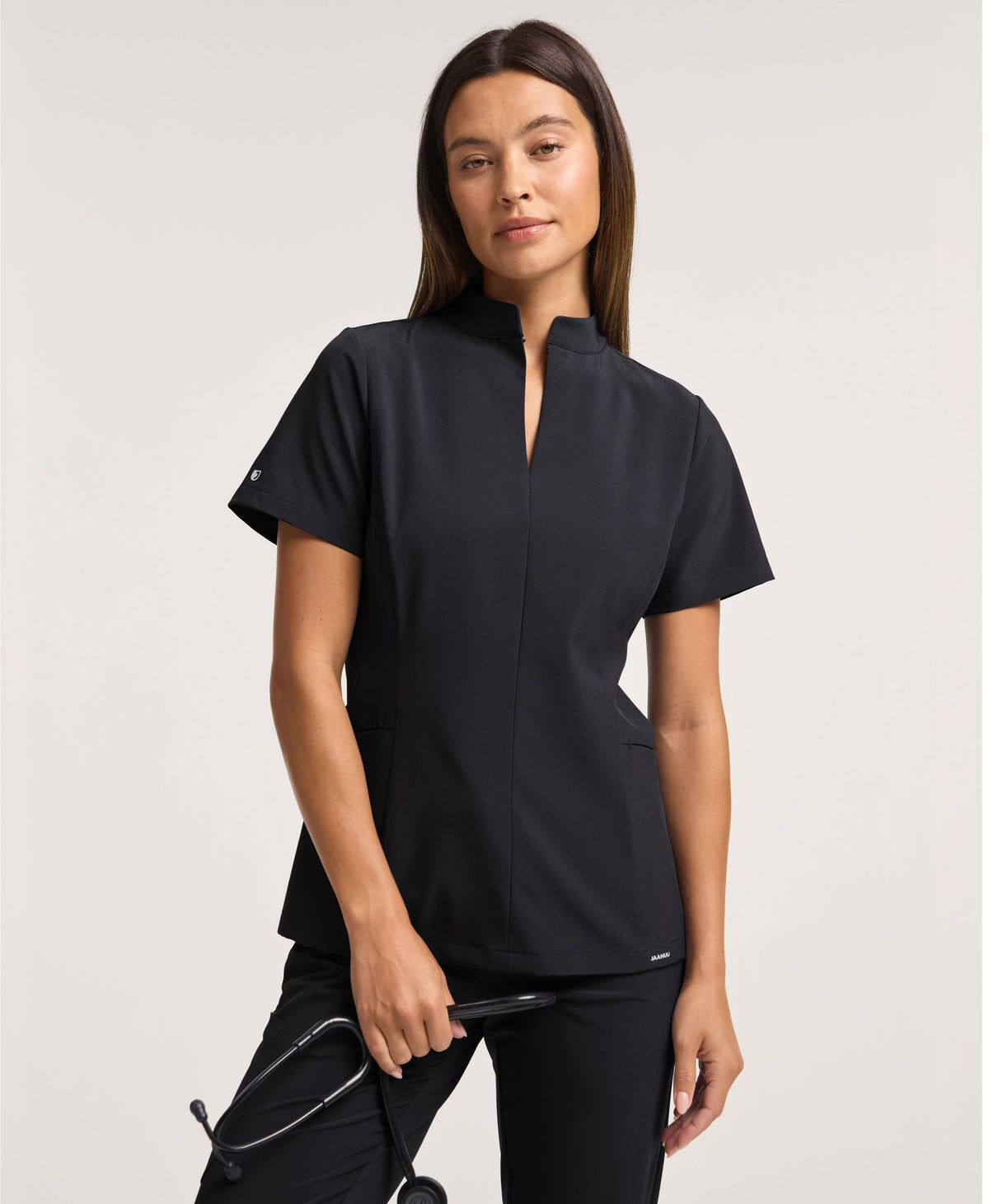 Jaanuu Alex Mock-Neck Scrub Top in Black, product photo 1 of 6