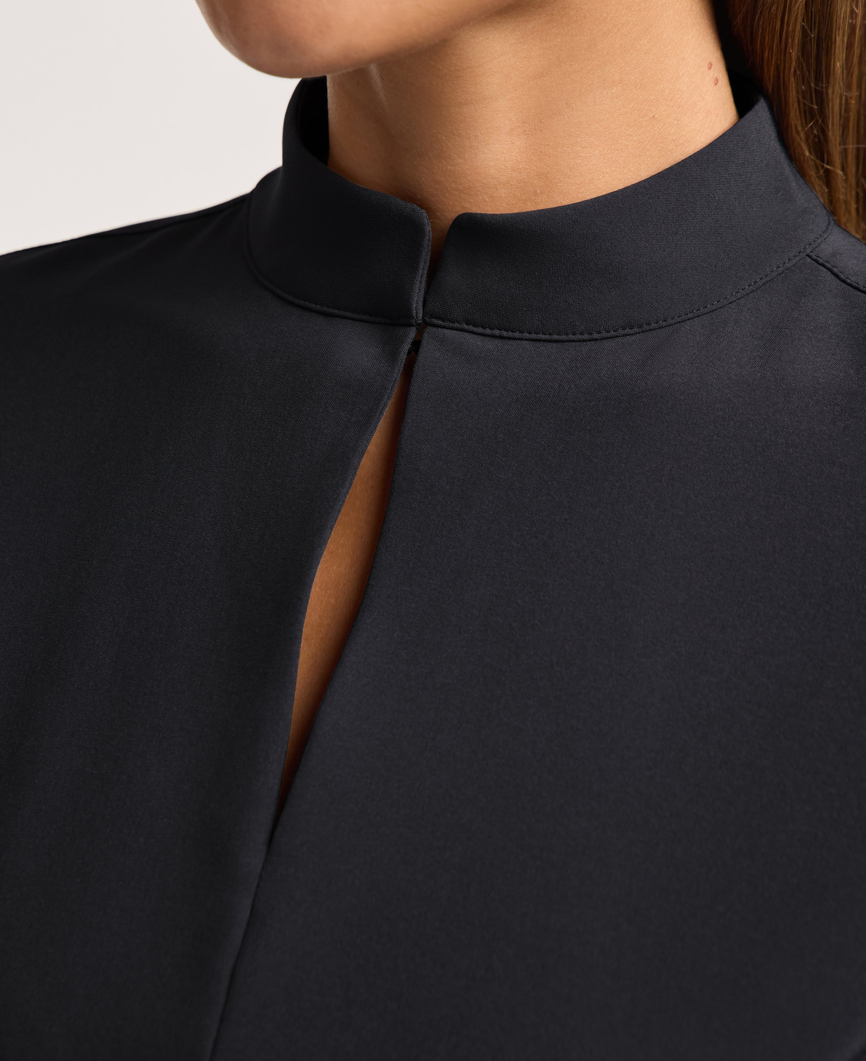 Jaanuu Alex Mock-Neck Scrub Top in Black, product photo 2 of 6