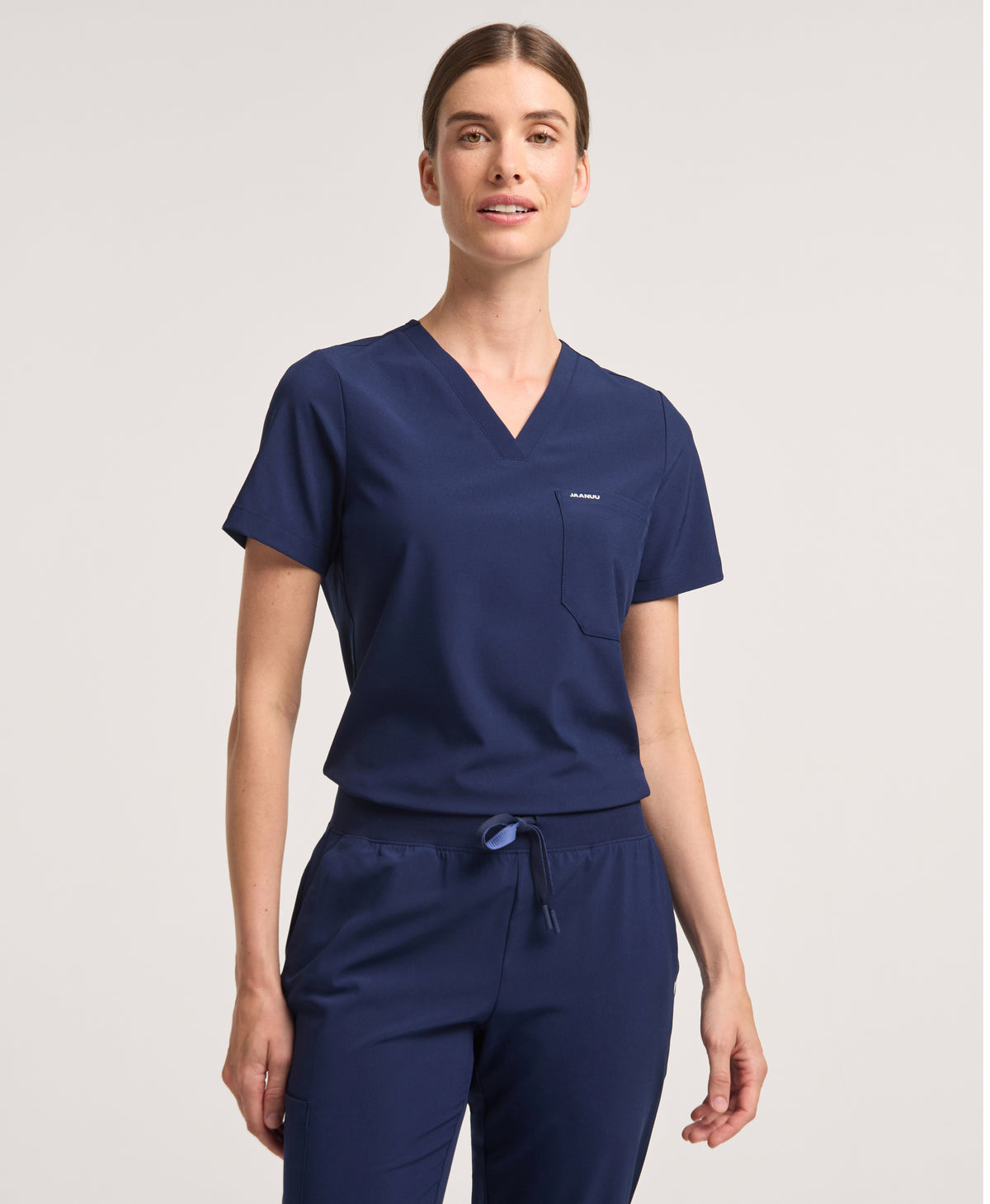 Jaanuu Harlow Slim 1-Pocket Scrub Top in Midnight Navy, product photo 1 of 6