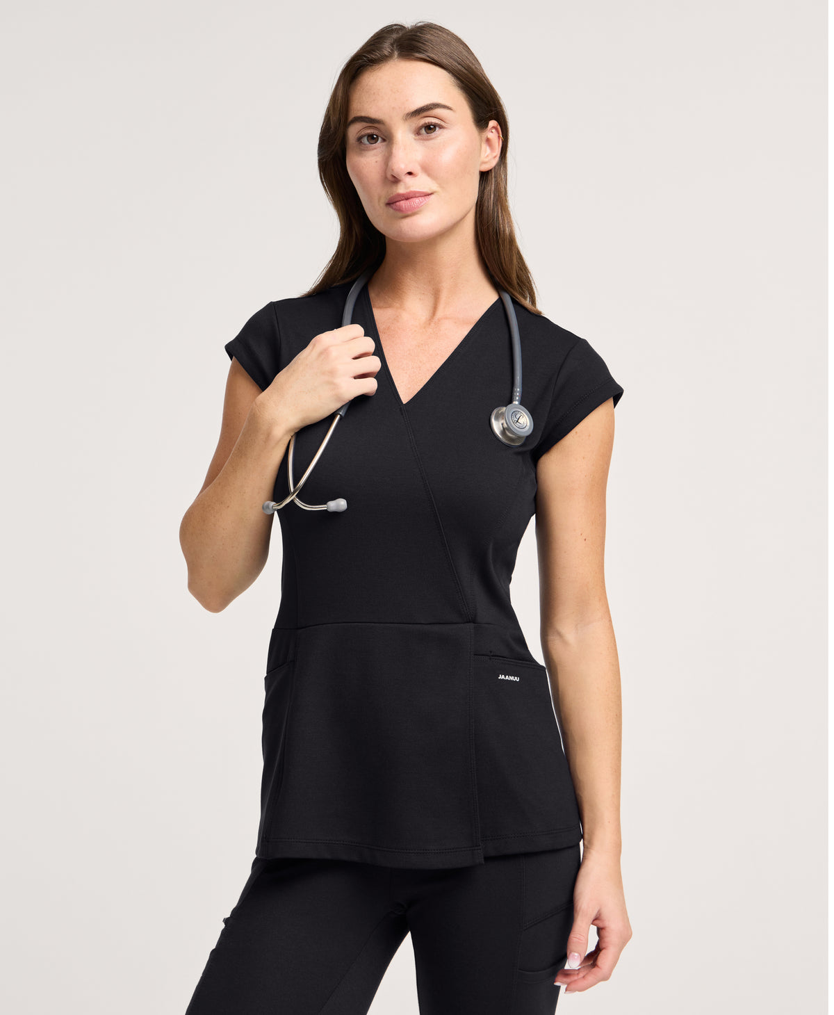 Jaanuu Isla Mock-Wrap Scrub Top in Black, product photo 1 of 6