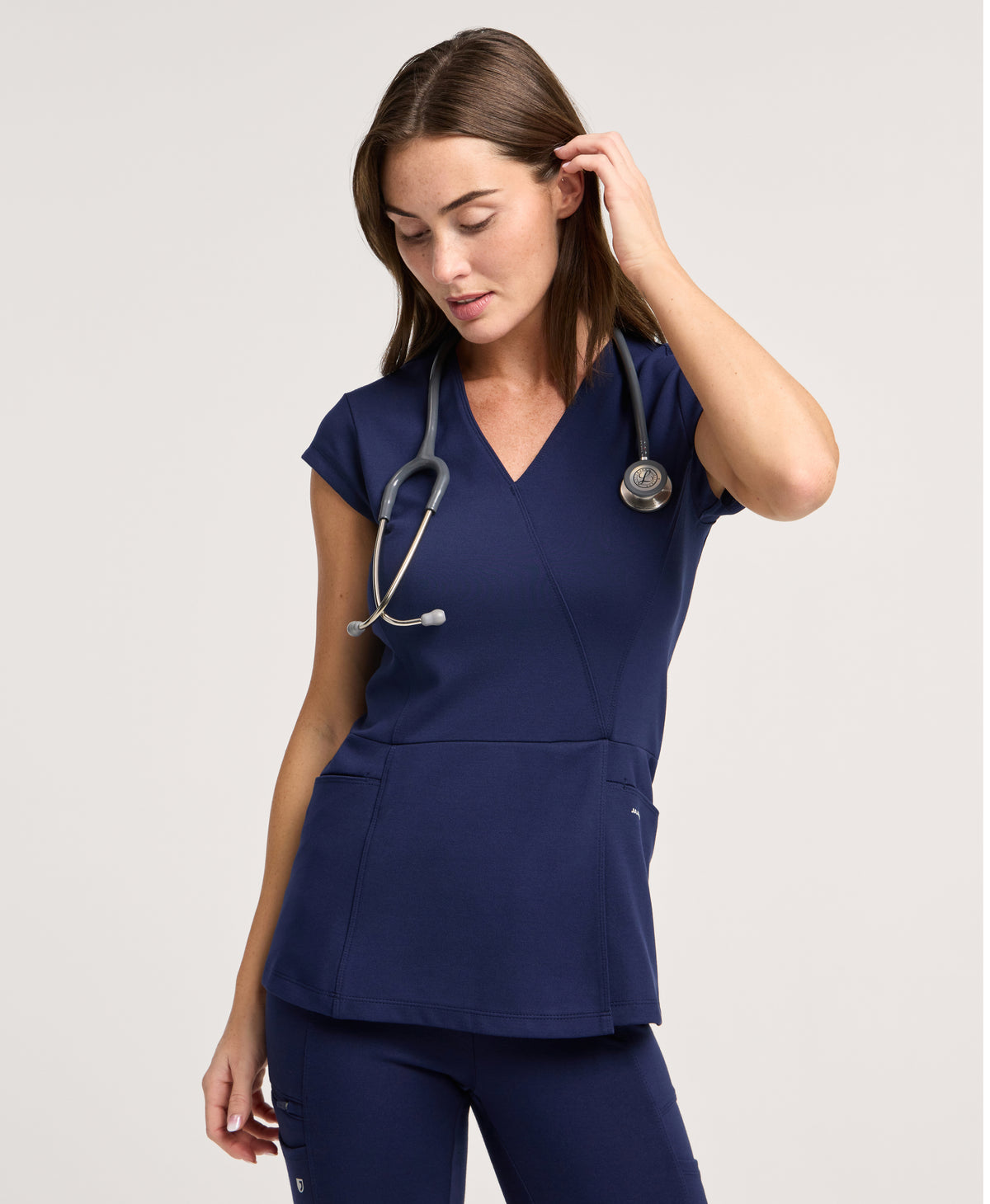 Jaanuu Isla Mock-Wrap Scrub Top in Midnight Navy, product photo 1 of 6