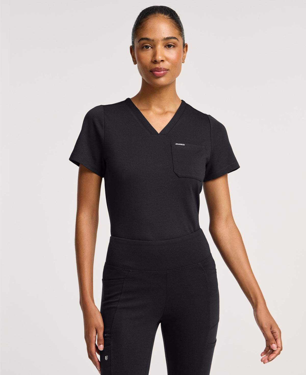Jaanuu Keva Slim 1-Pocket Scrub Top in Black, product photo 1 of 6