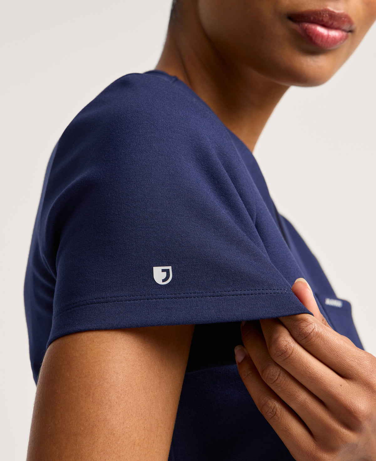 Jaanuu Keva Slim 1-Pocket Scrub Top in Midnight Navy, product photo 2 of 6
