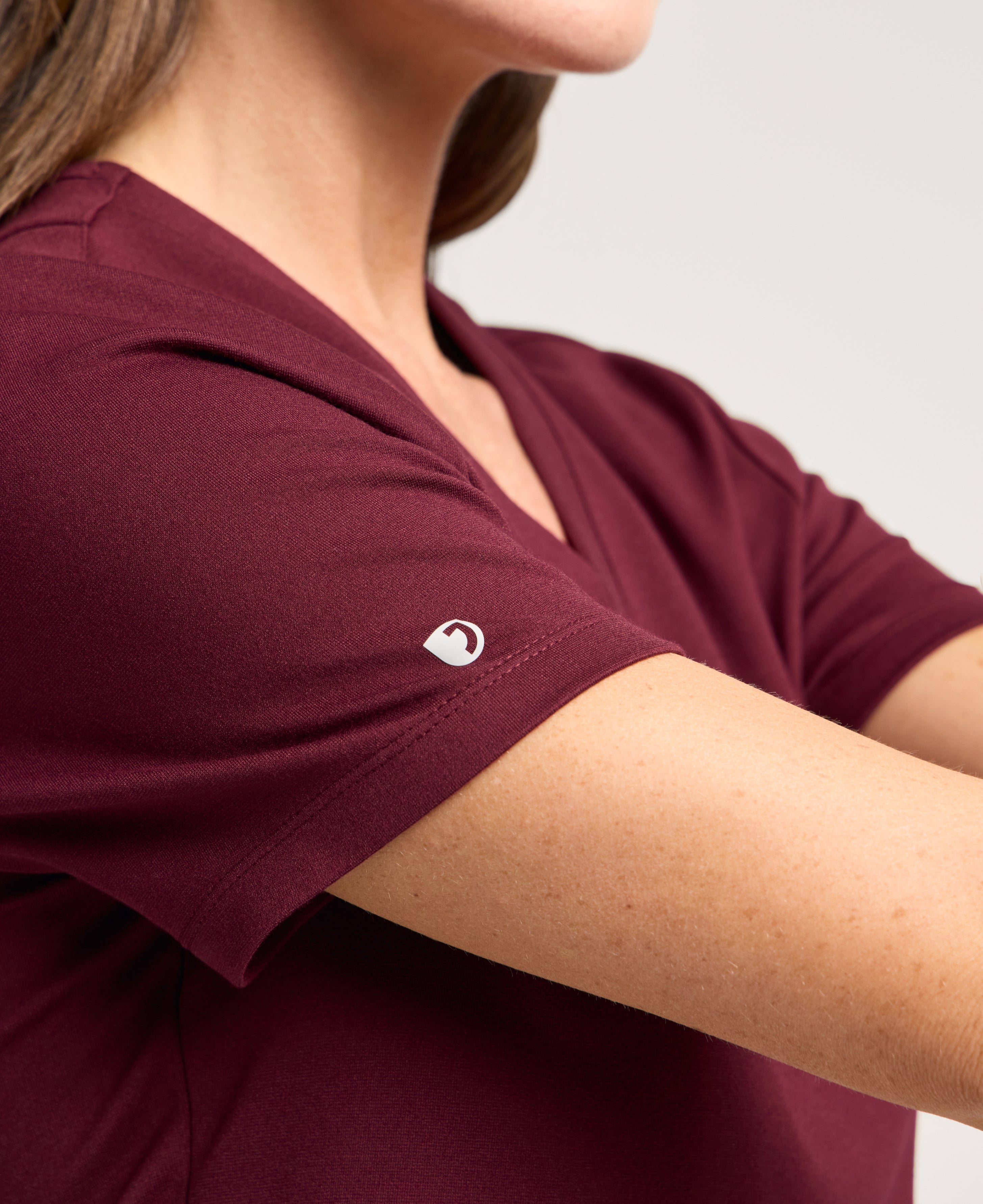 Jaanuu Kass Slim 4-Pocket Scrub Top in Burgundy, product photo 3 of 6