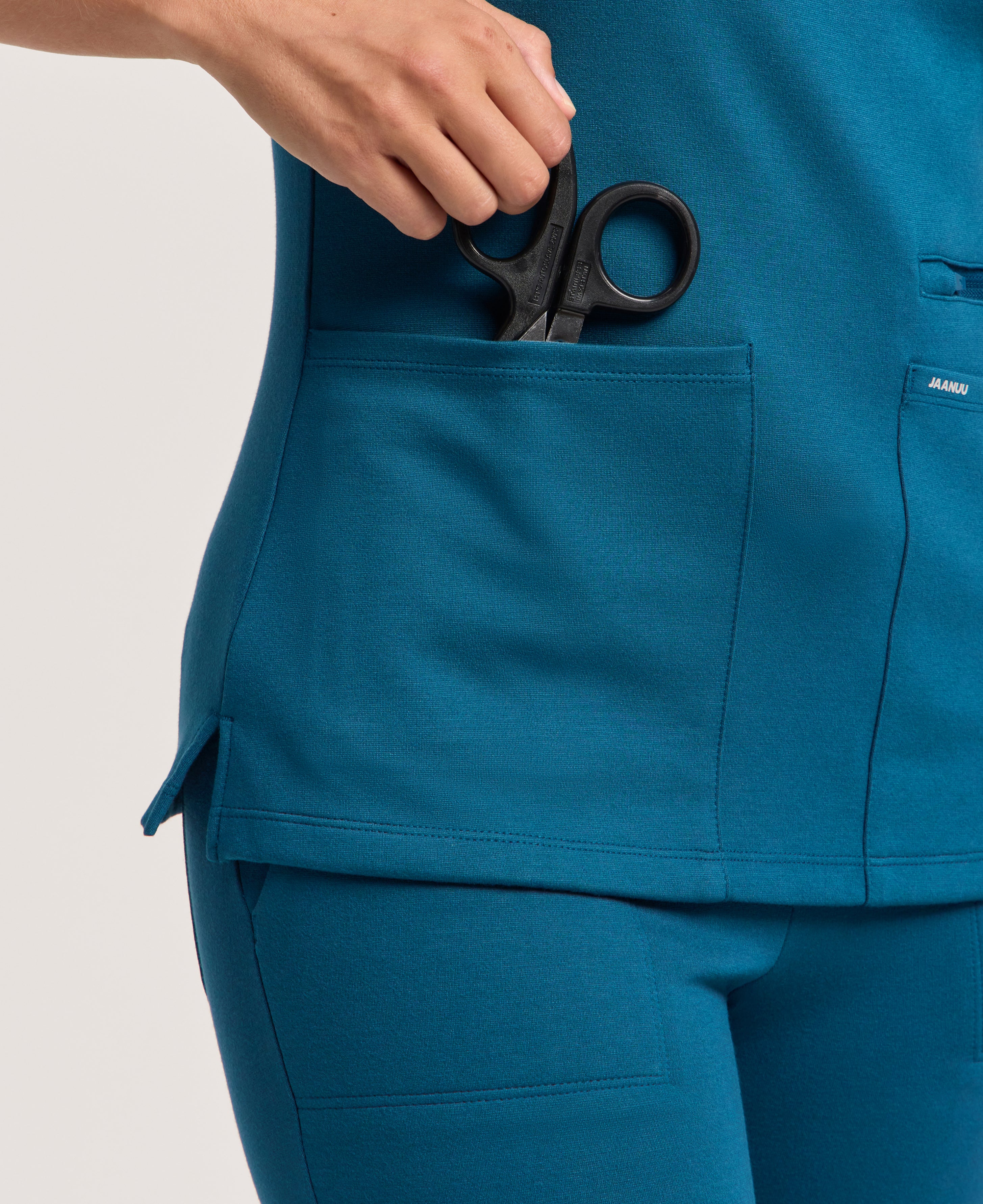Jaanuu Kass Slim 4-Pocket Scrub Top in Caribbean Blue, product photo 3 of 6