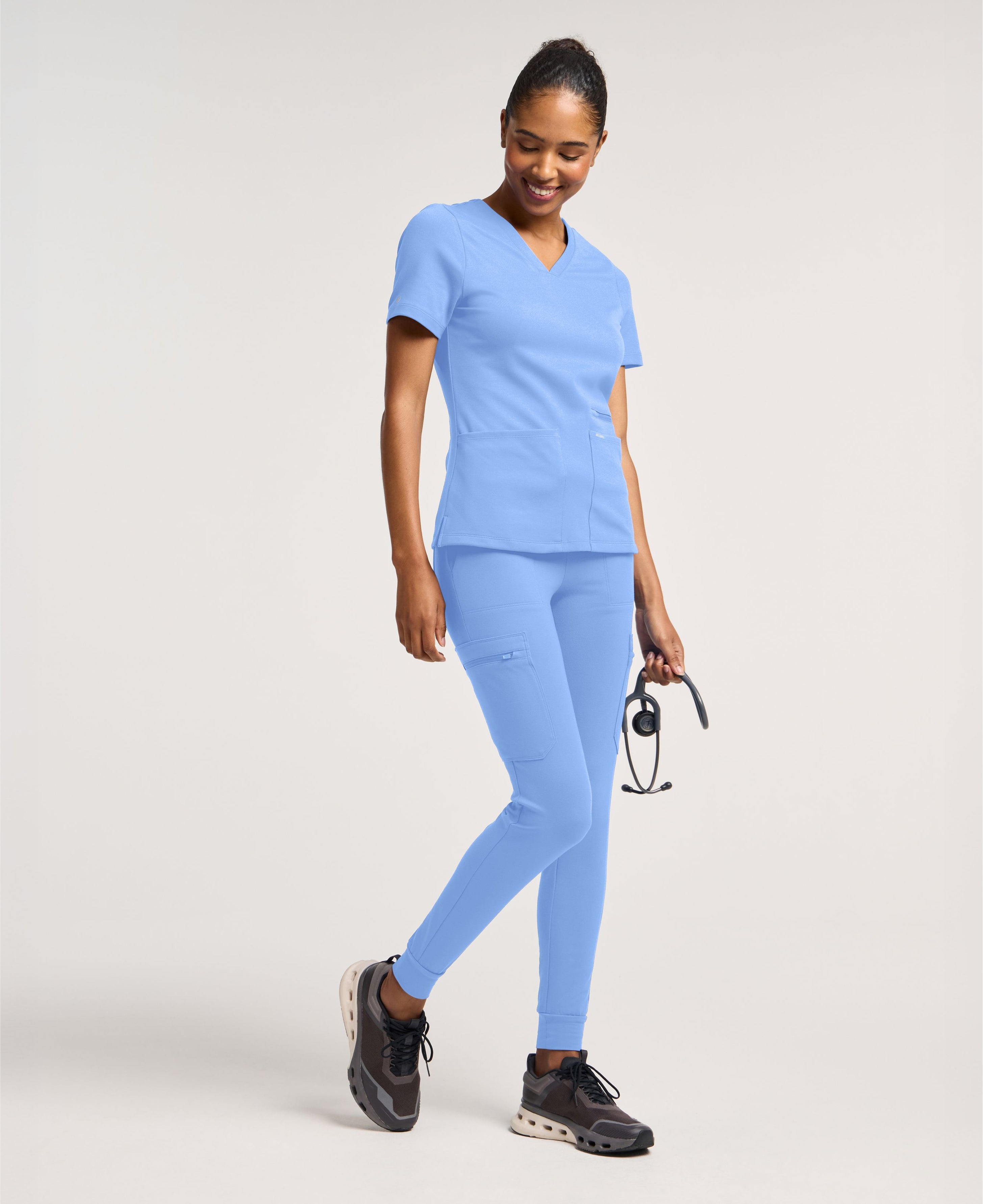 Jaanuu Kass Slim 4-Pocket Scrub Top in Ceil Blue, product photo 5 of 6