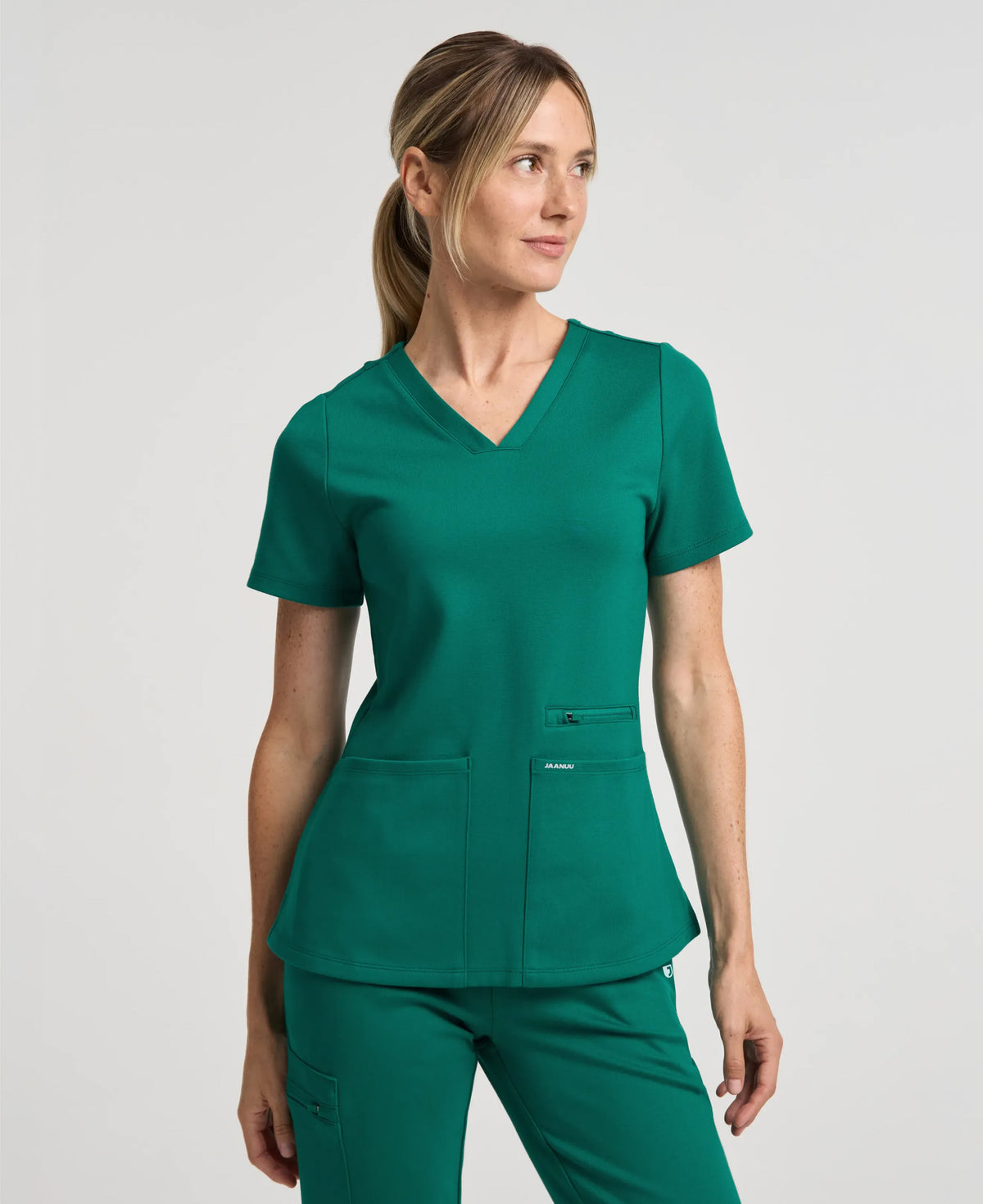 Jaanuu Kass Slim 4-Pocket Scrub Top in Hunter Green, product photo 1 of 6