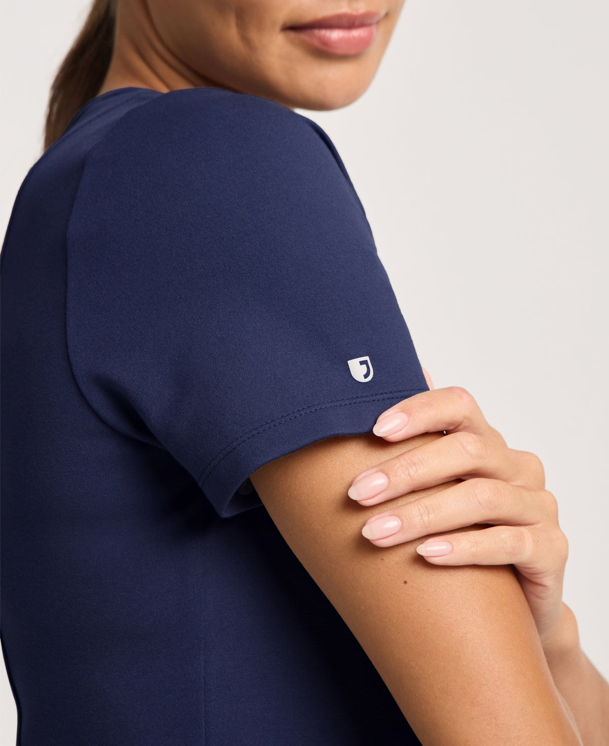 Jaanuu Kass Slim 4-Pocket Scrub Top in Midnight Navy, product photo 2 of 6