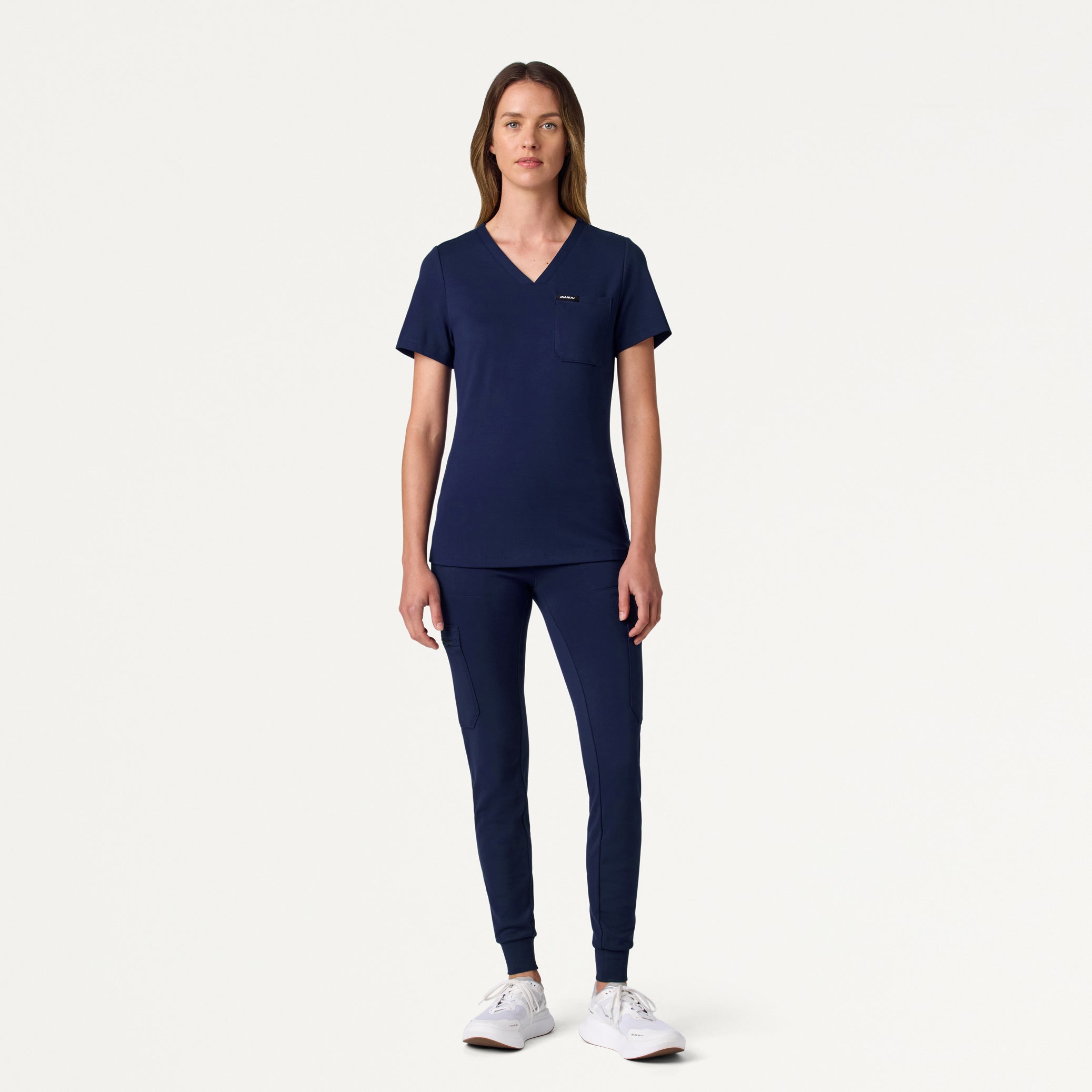 Woman wearing a Midnight Navy scrub top and scrub pant
