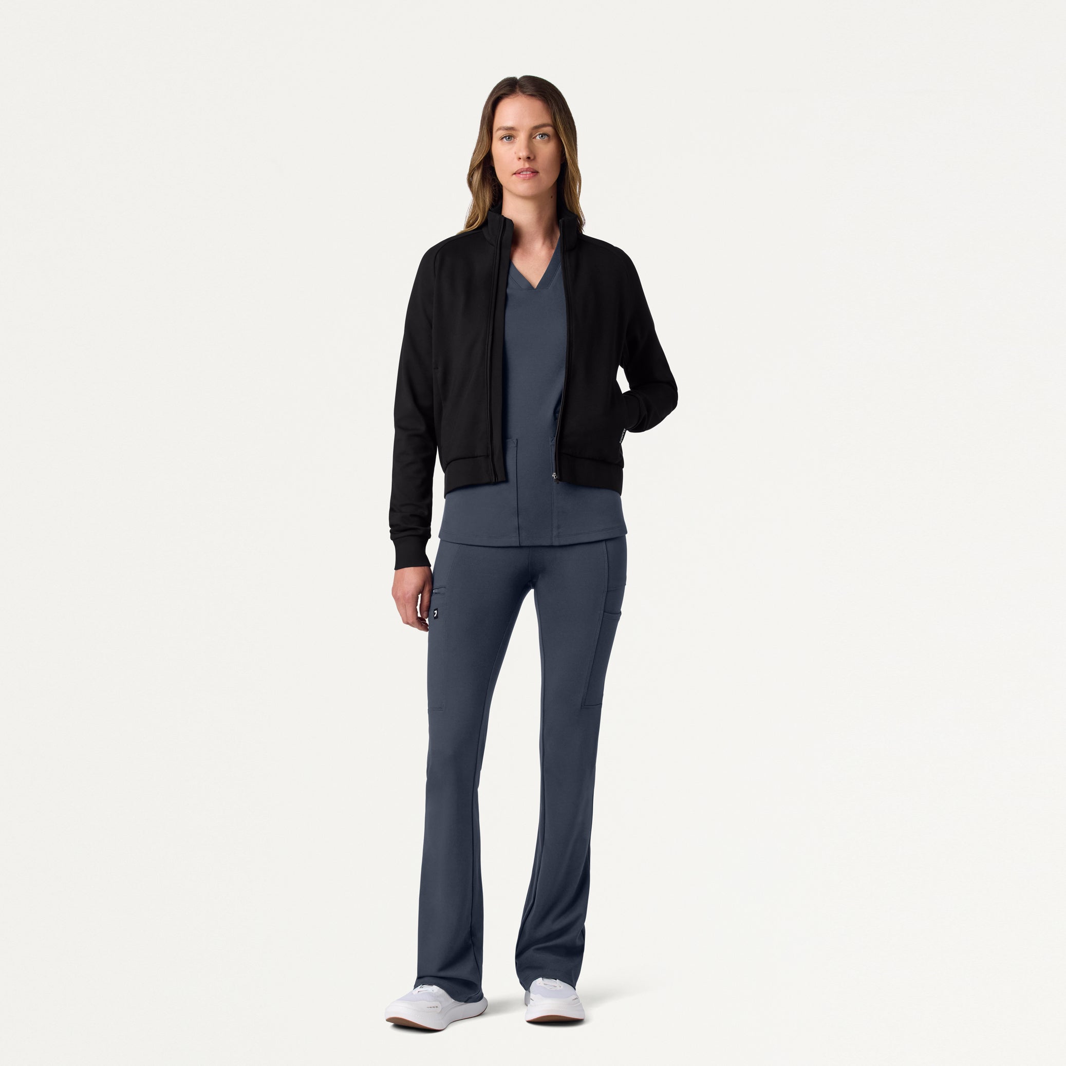Woman wearing Carbon Gray scrubs with Black scrub jacket