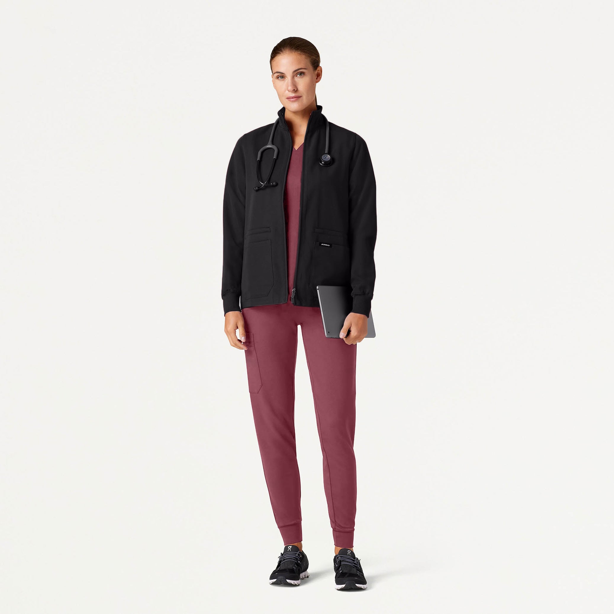 Woman in Rosewood scrubs and jacket