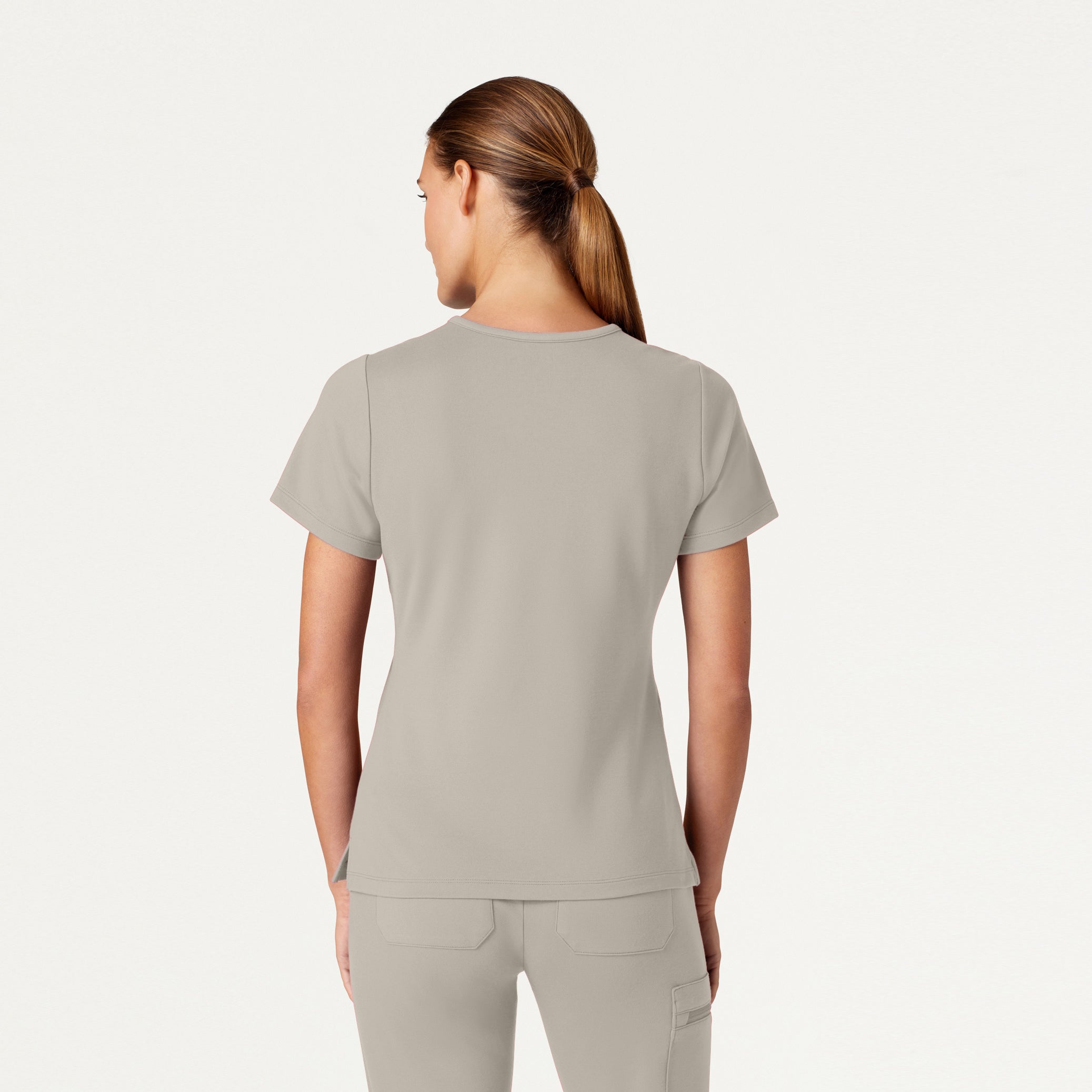 Woman wearing Fog color scrub set.