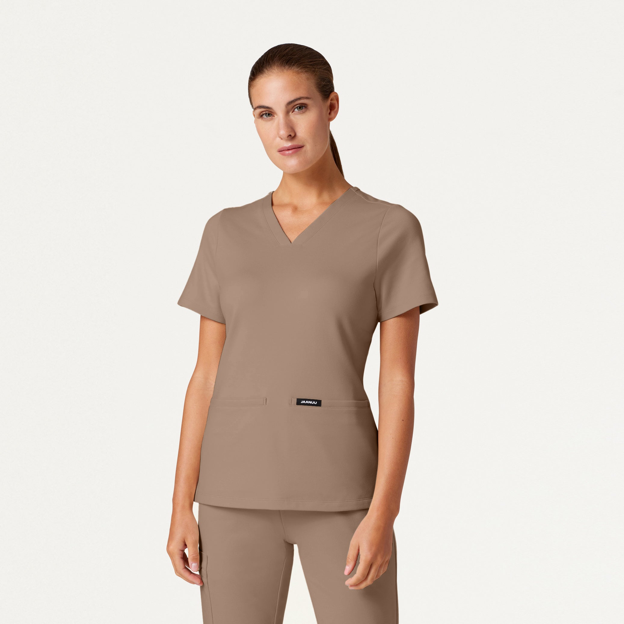 Woman wearing a Mocha scrub top