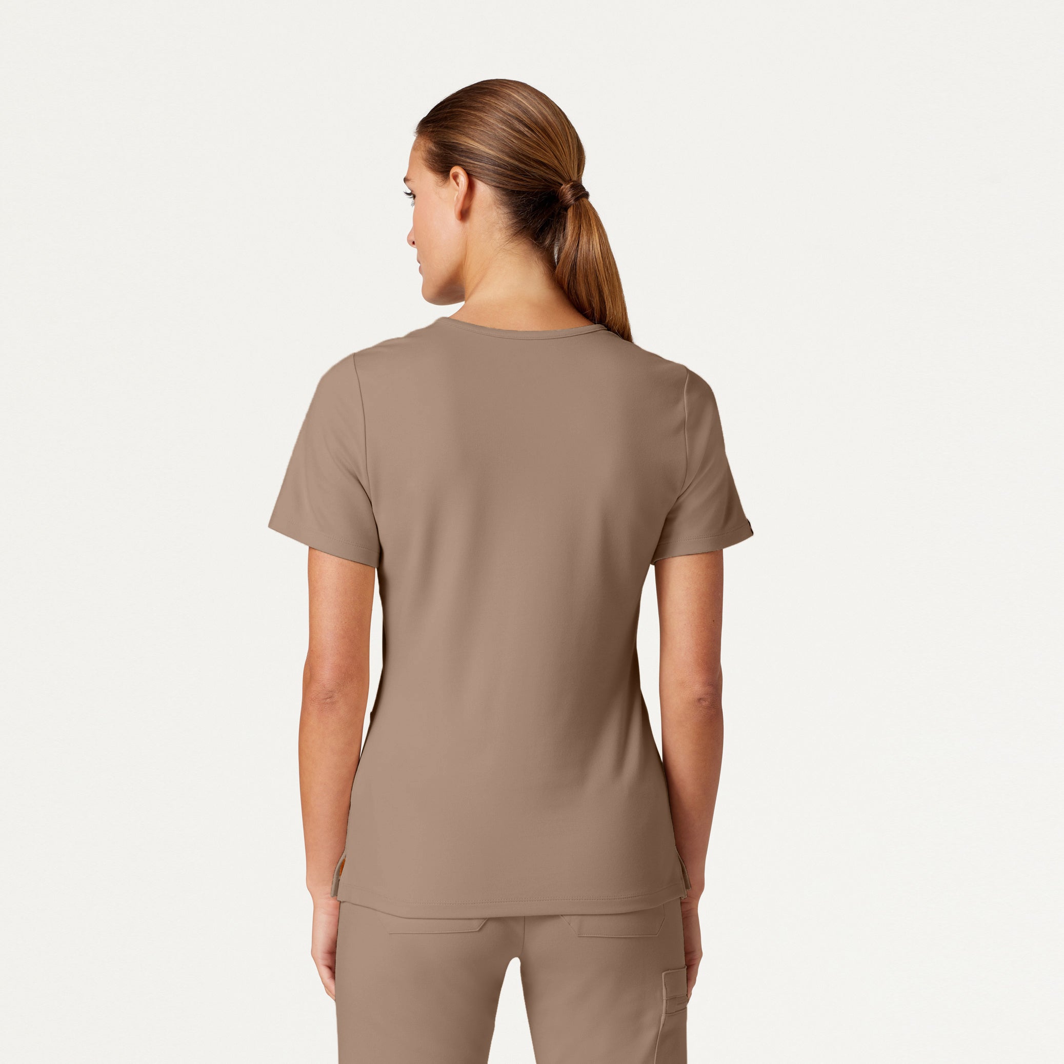 Woman wearing a Mocha scrub top