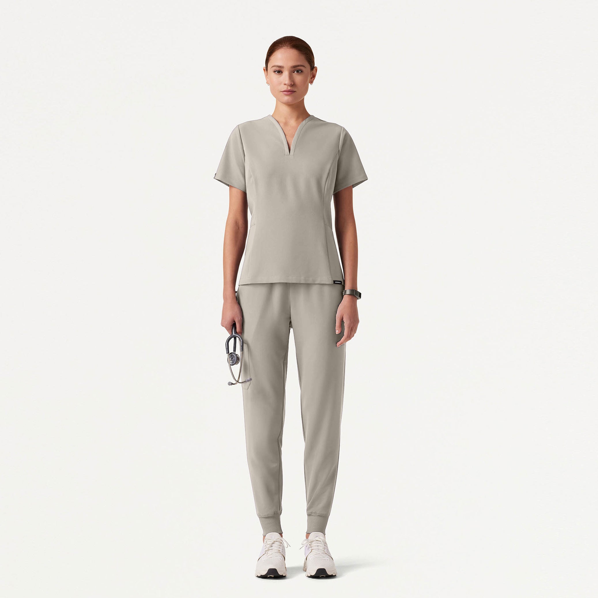 Person wearing a Fog colored scrub set on a white background