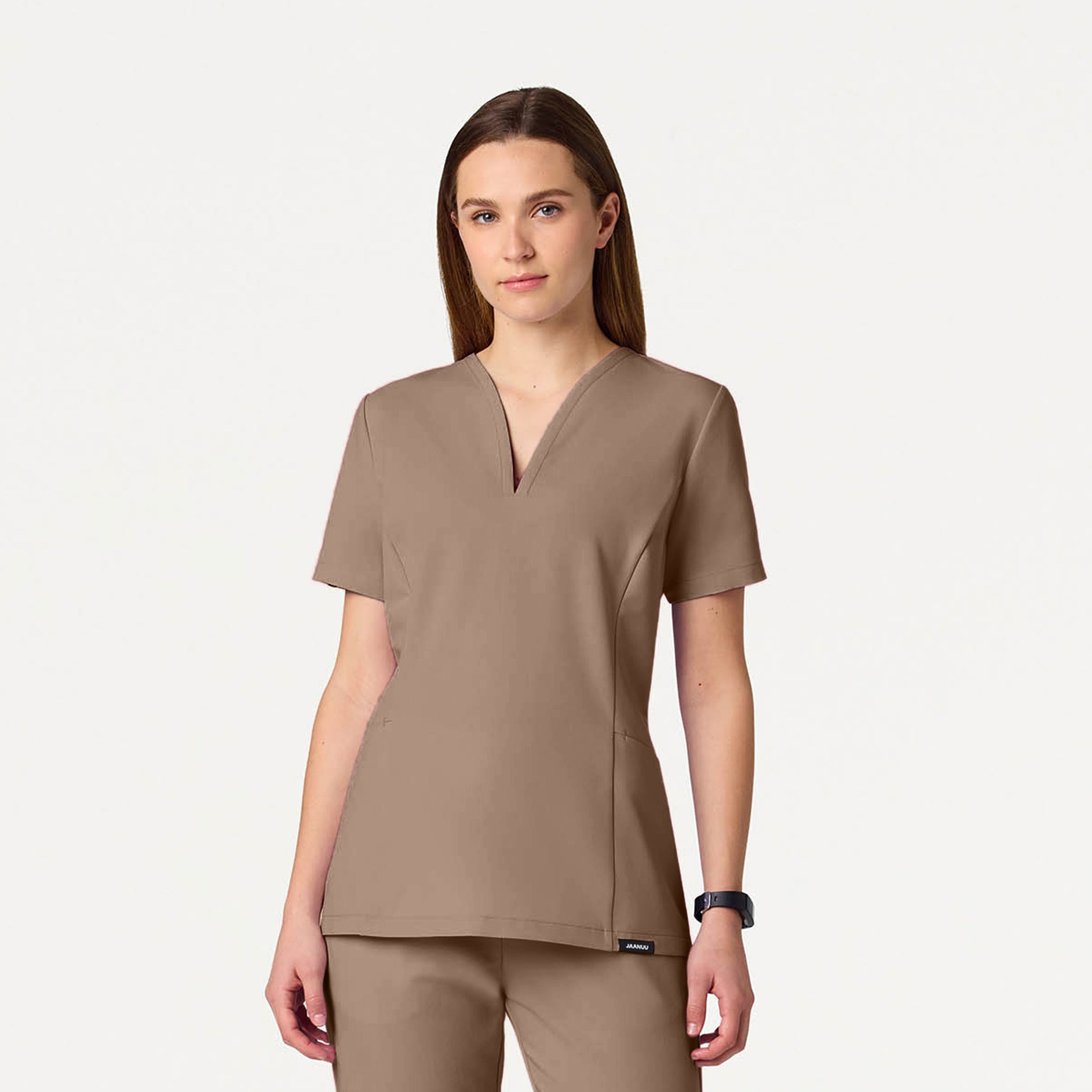 A woman wearing a Mocha scrub top