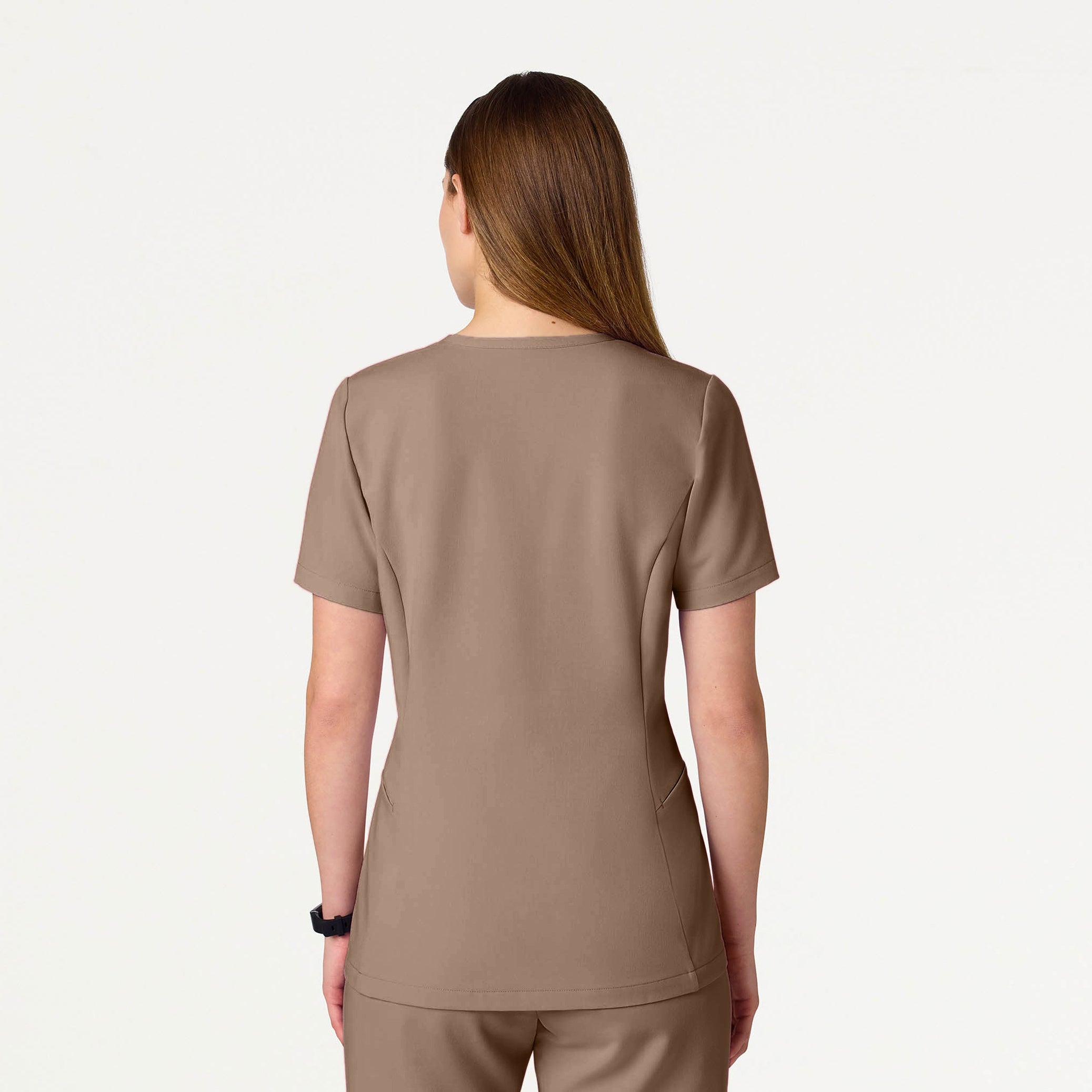 A woman wearing a Mocha scrub top