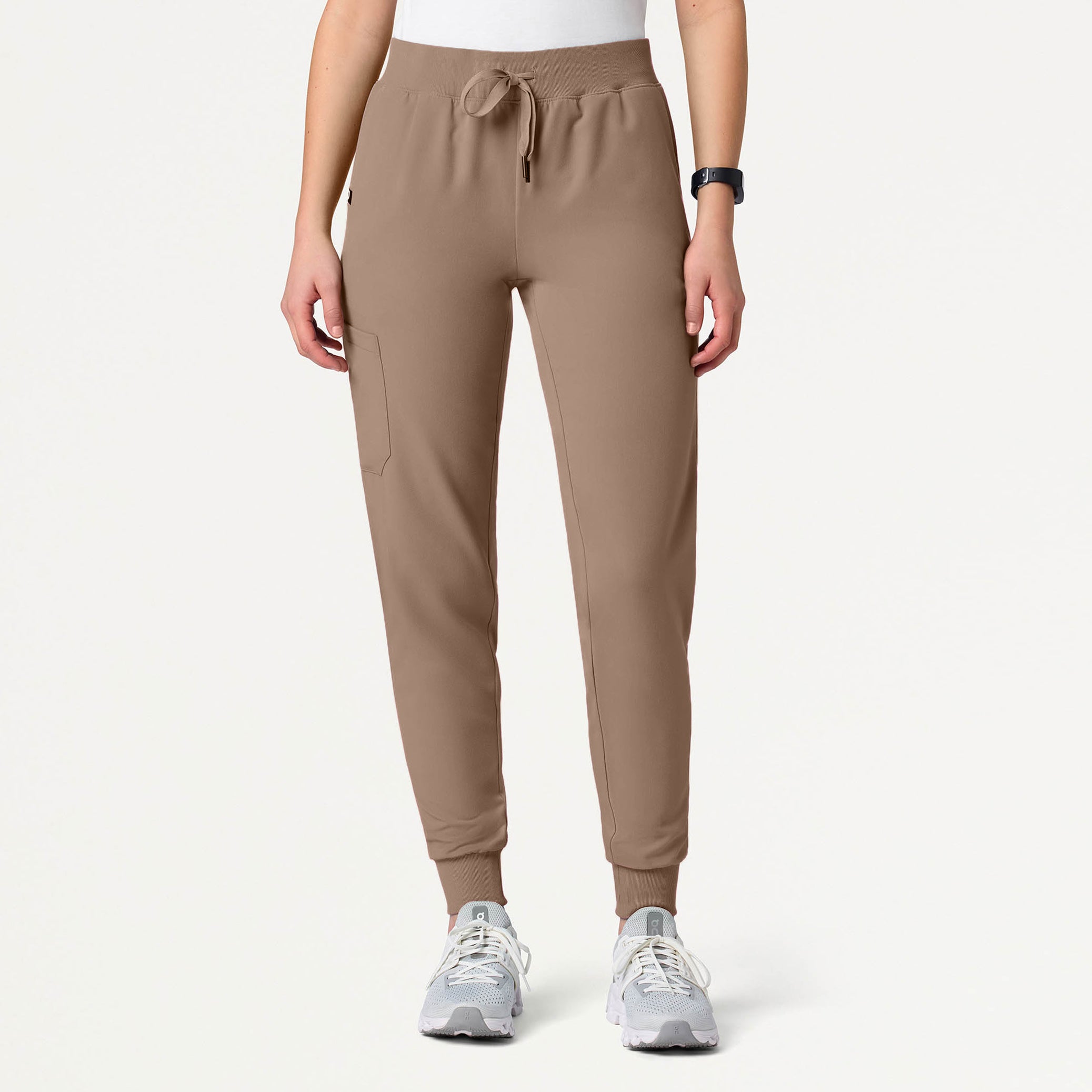 A woman wearing a Mocha scrub pant