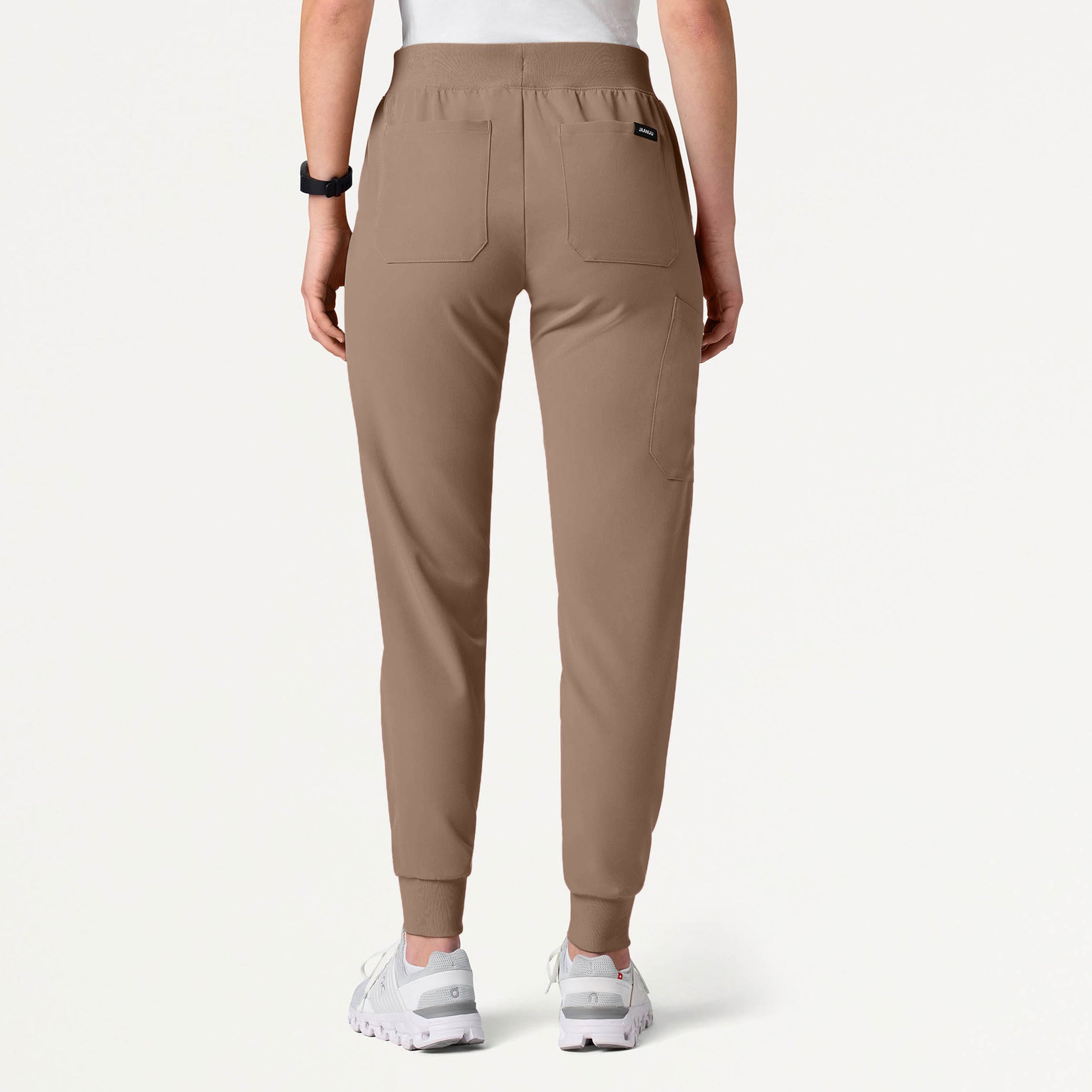 A woman wearing a Mocha scrub pant
