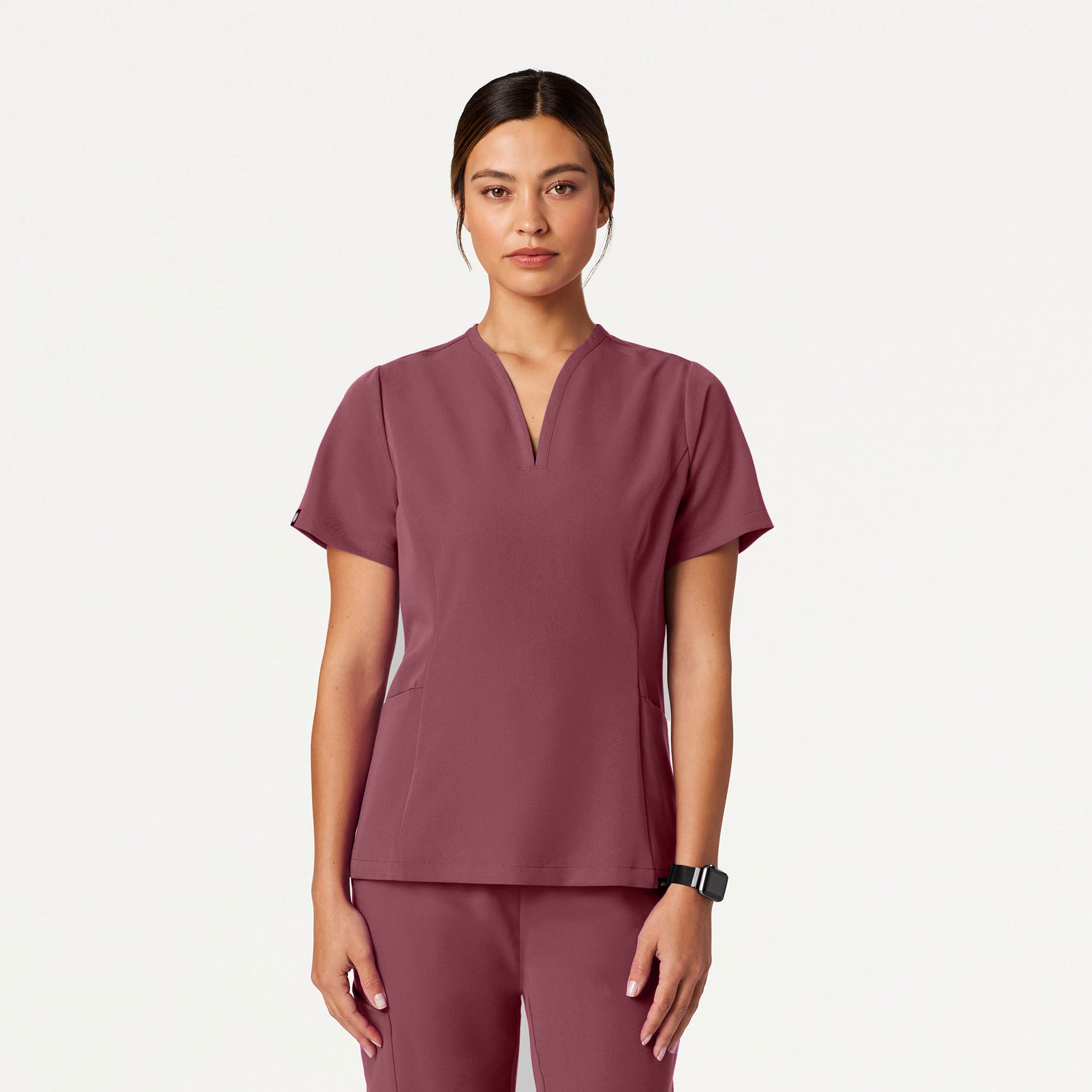 Person wearing a Rosewood scrub set on a white background